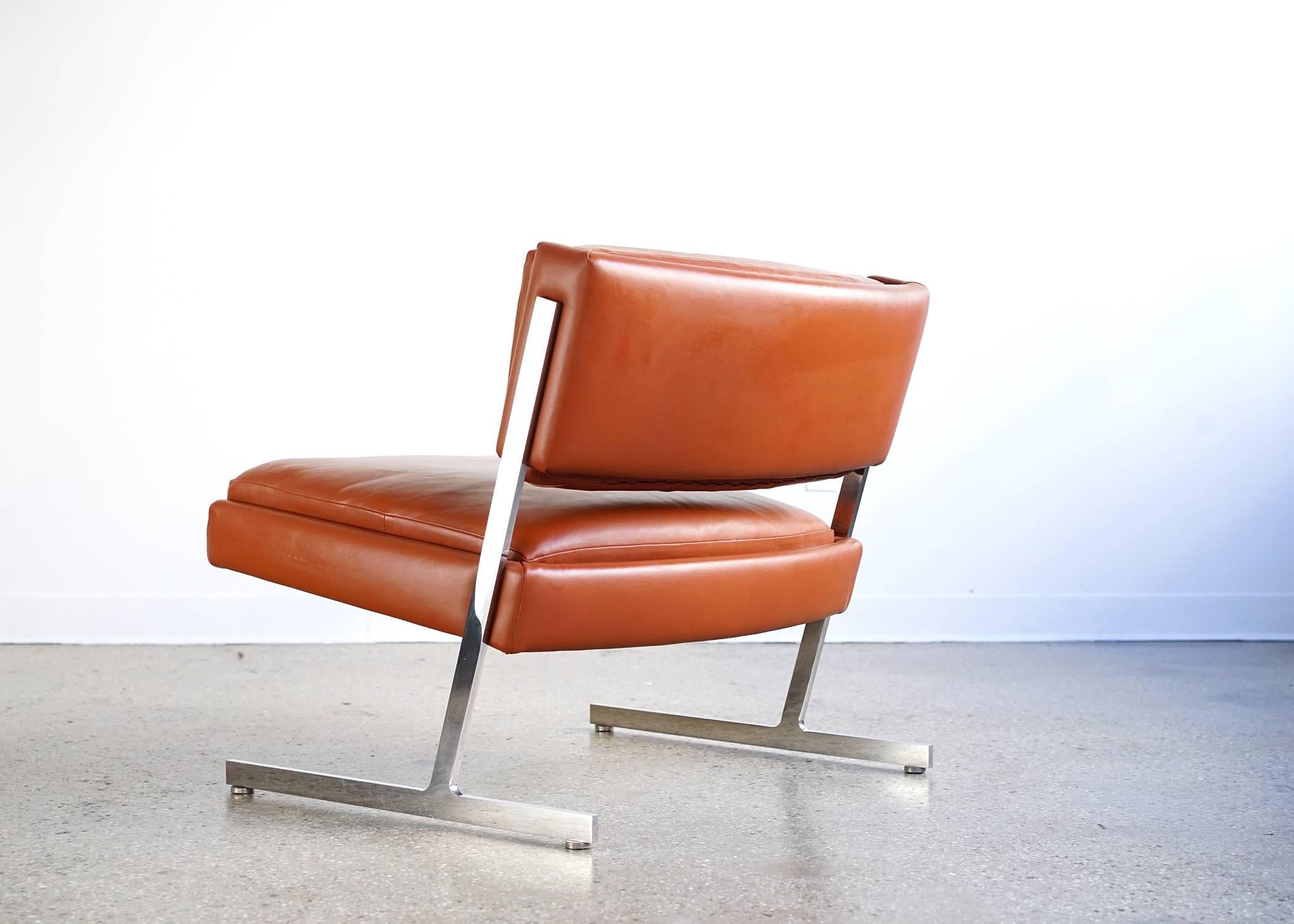 Bright polished steel frame. Fine leather upholstery. Slim, light, cantilevered silhouette. Handsome and comfortable.