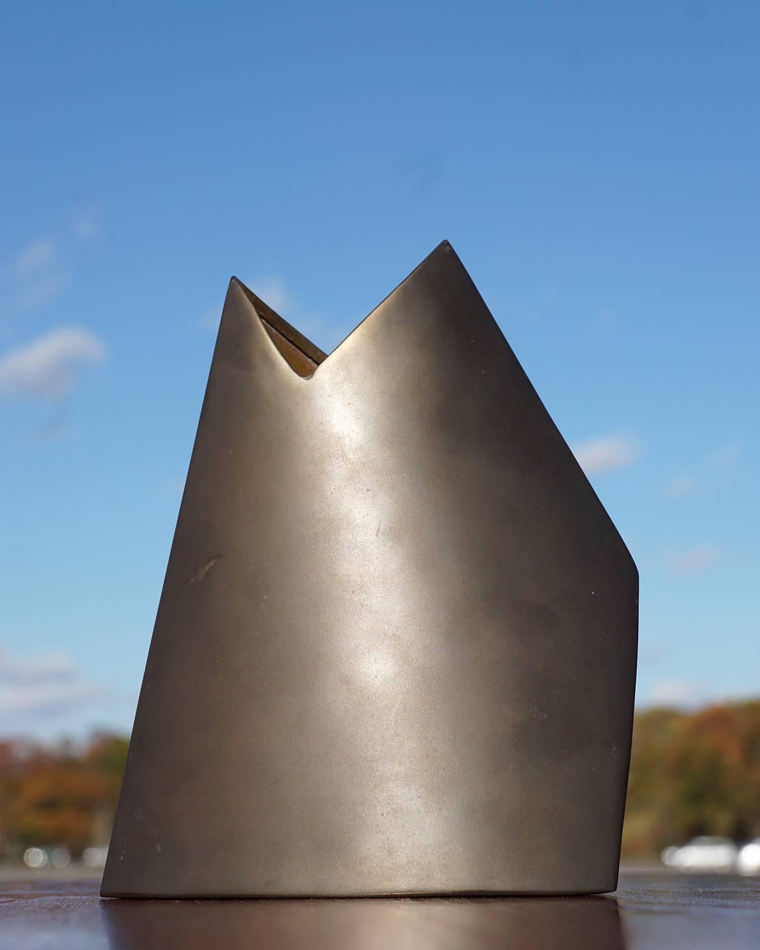 Dynamic composition of curved and angled surfaces with lovely natural patina and warm, bronze tone. Signed.