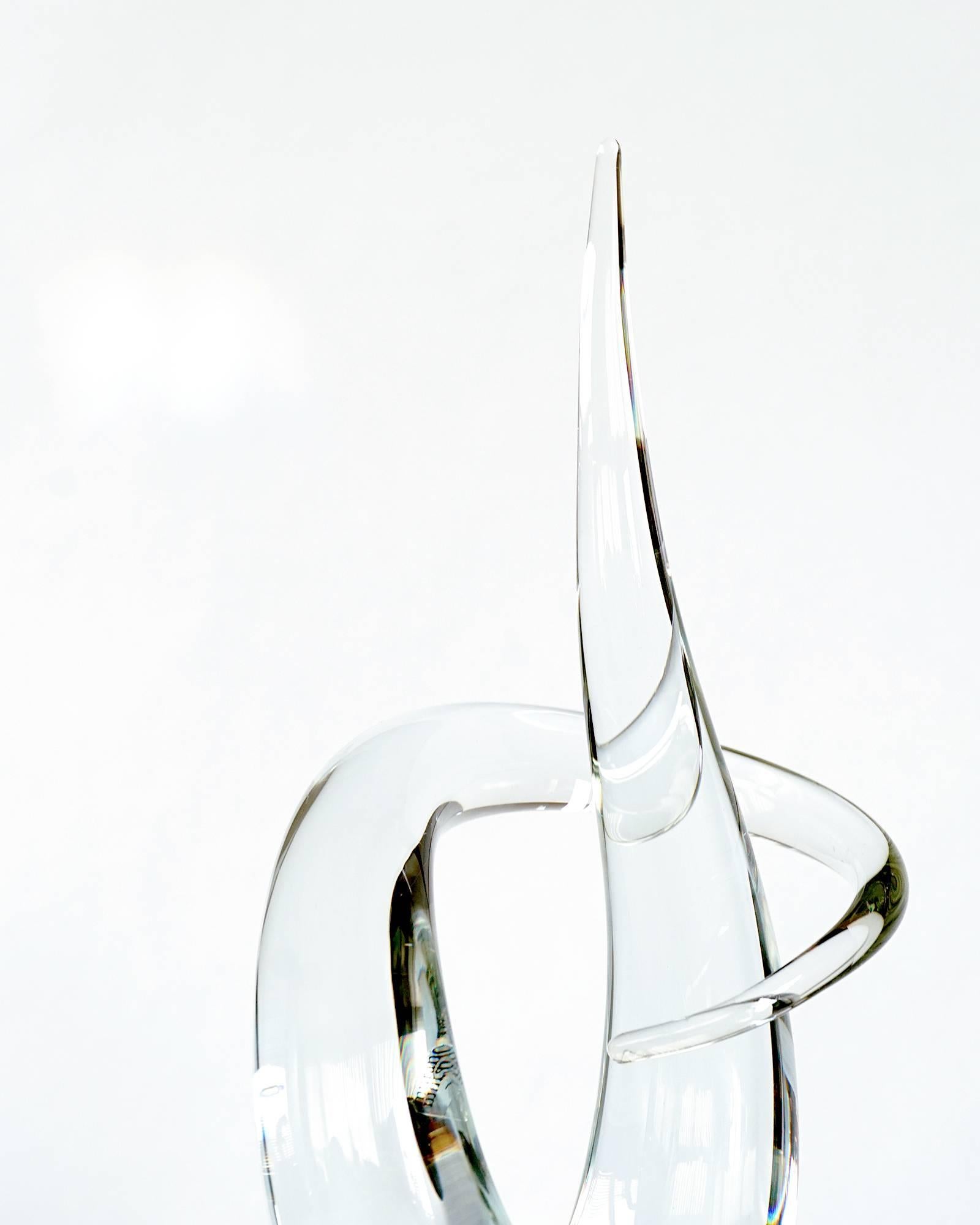 Sinuous modern form. Brilliant clear glass. Solid black glass cube base. Etched signature and Vetri Murano sticker.