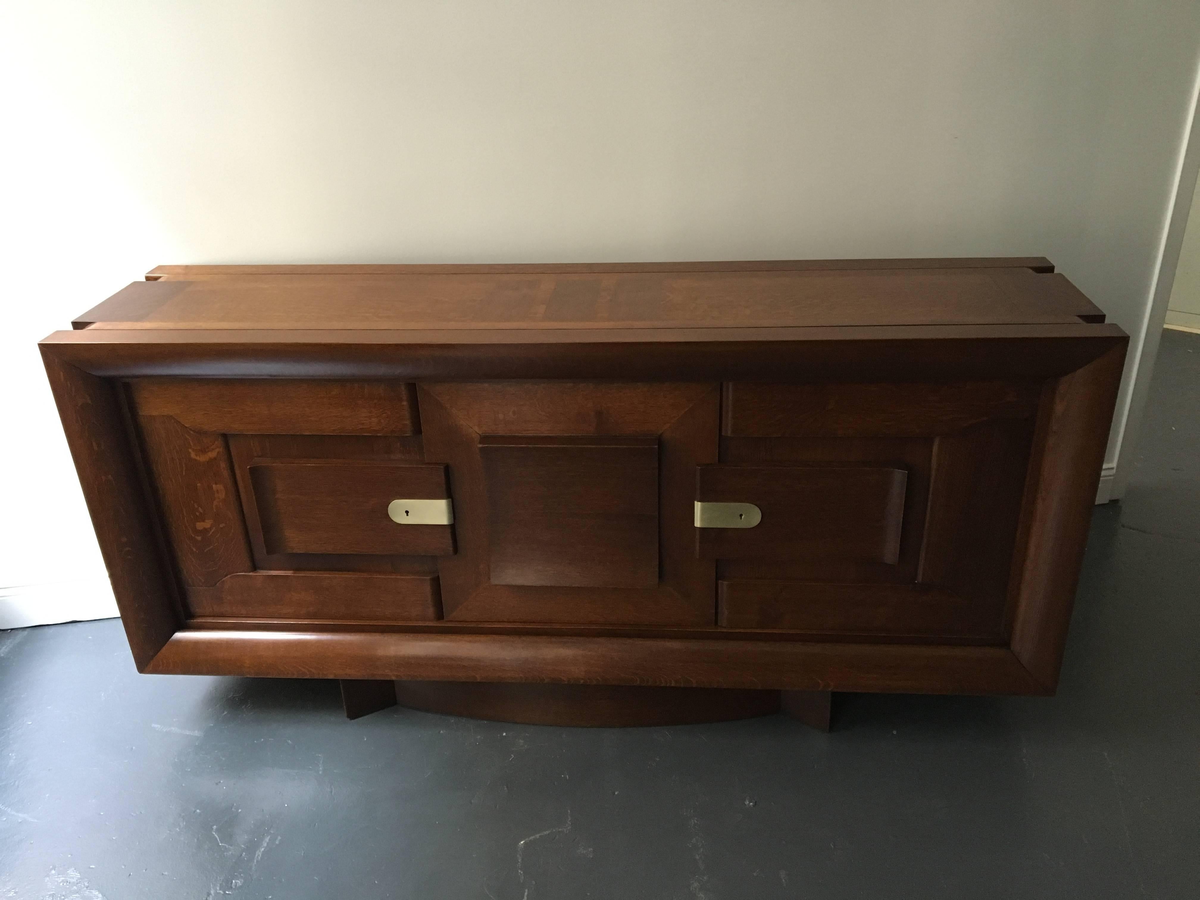 A rare sideboard by Charles Dudouyt with two doors that open to an interior with a center shelf and two small drawers. The center door does not open, but rolls left or right. The sideboard is made of solid oak and veneered oak. This sideboard was