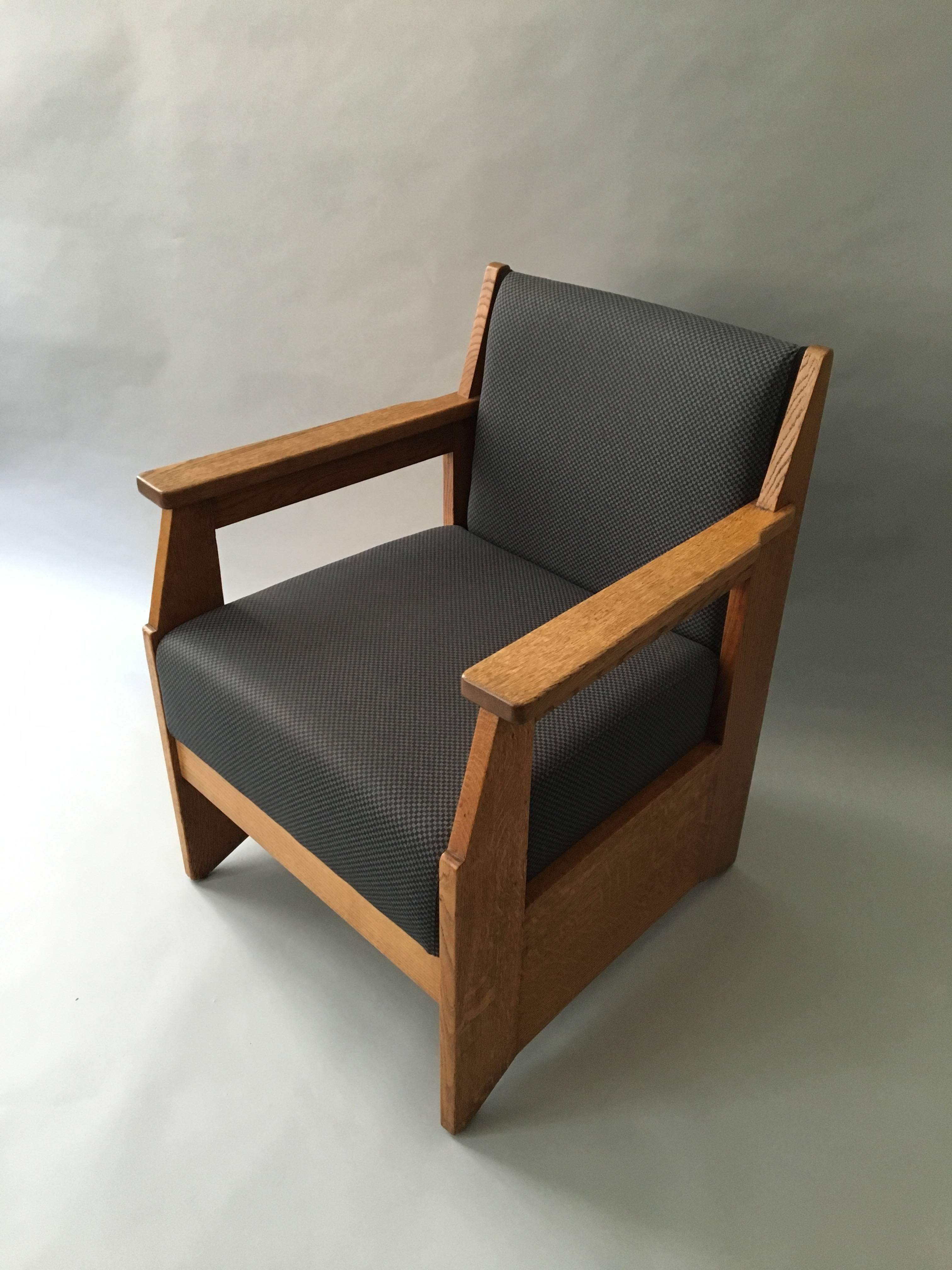 The armchairs are made in oak and re-upholstered. They where originally made in 1924. Hendrik Wouda was one of the most well known architect/Designers from The Hague School in Holland. The armchairs have the Pander & Son stamp underneath each