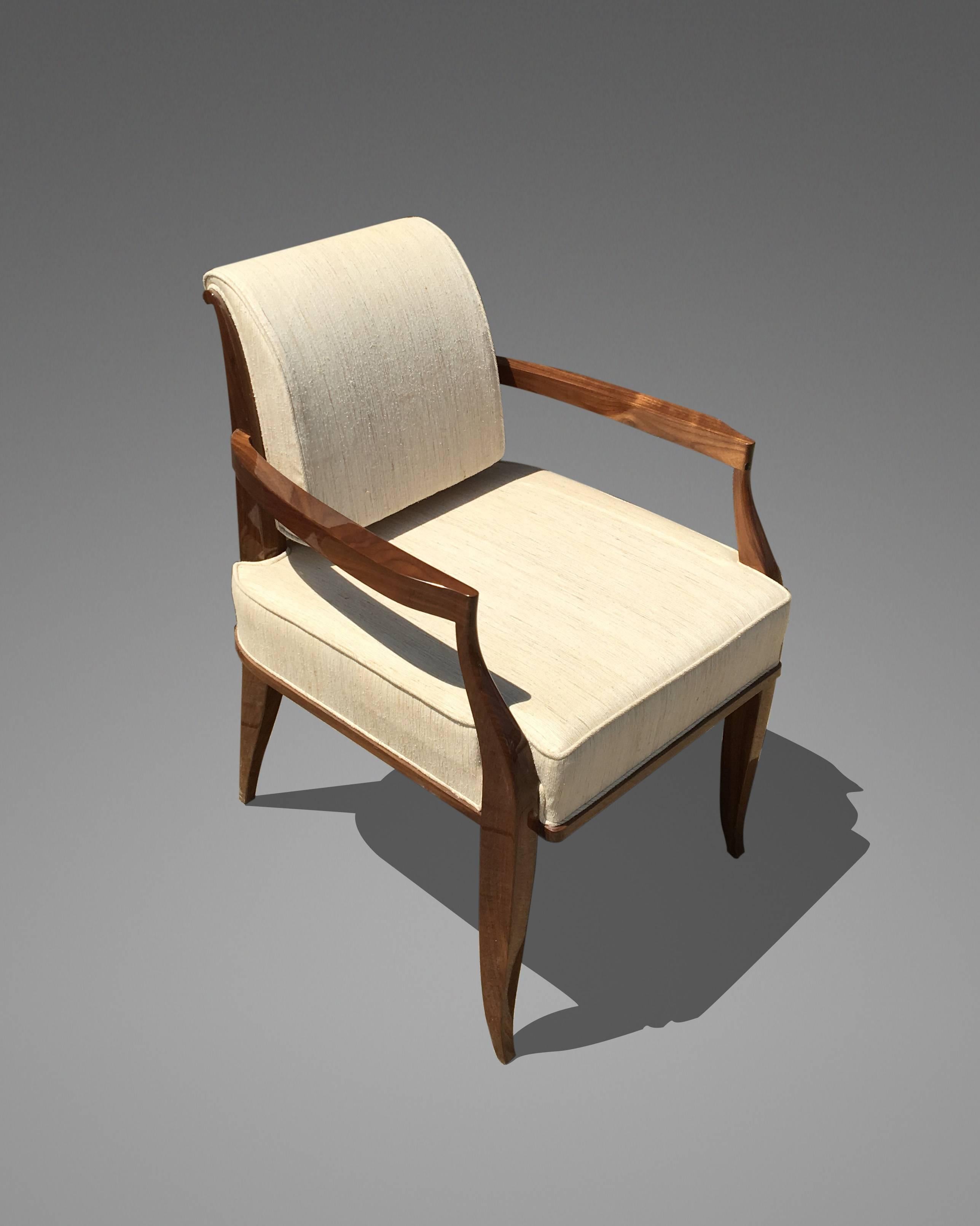 Armchair made of walnut with a high polish. The armchair is part of a set: Including two armchairs and six side chairs.