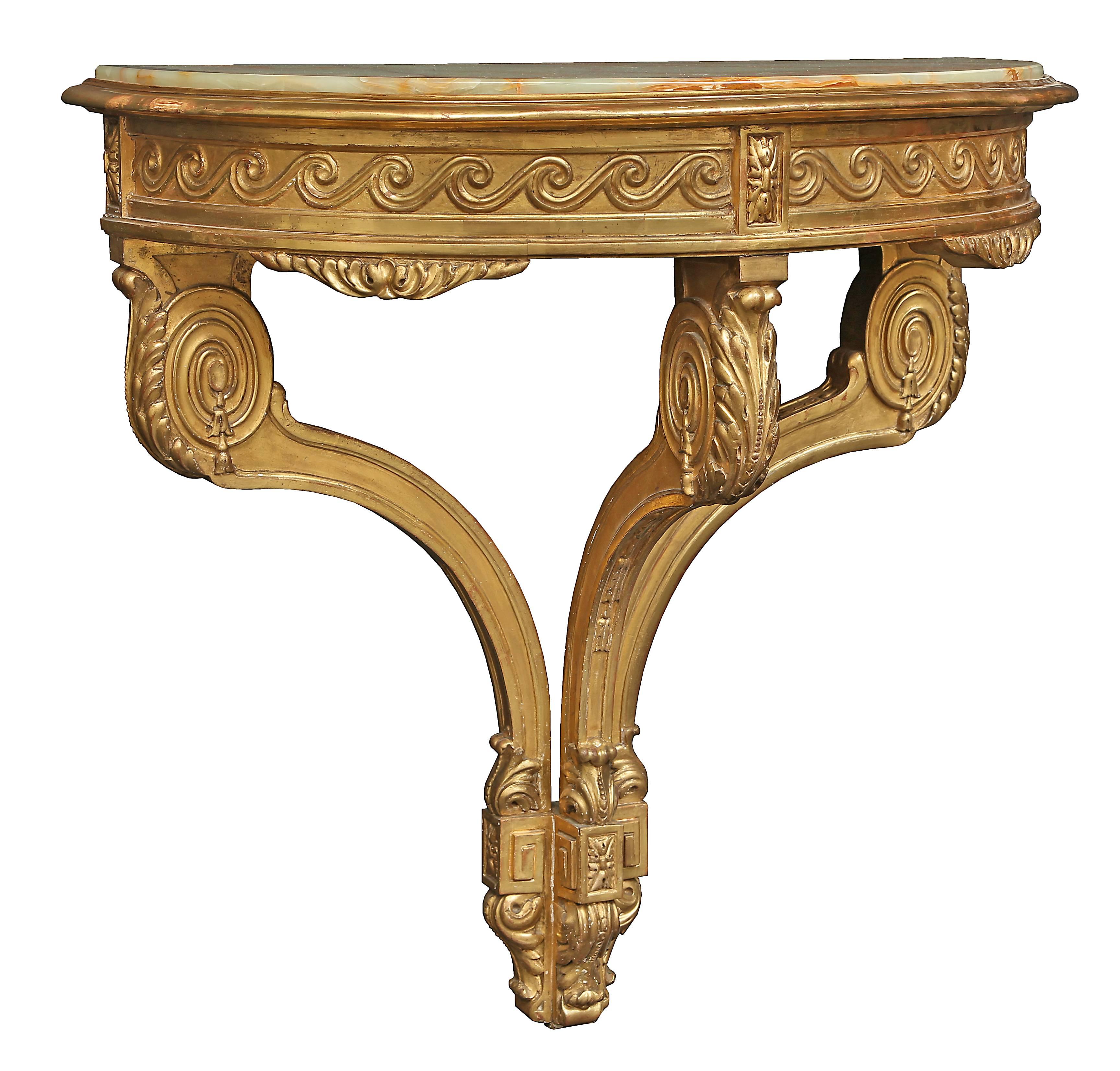 A striking French 19th century Louis XVI style giltwood wall-mounted demilune console with its original fitted onyx top. The console is raised by an acanthus leaf bottom support with an elegant carved block rosette flanked by a Greek key design. The