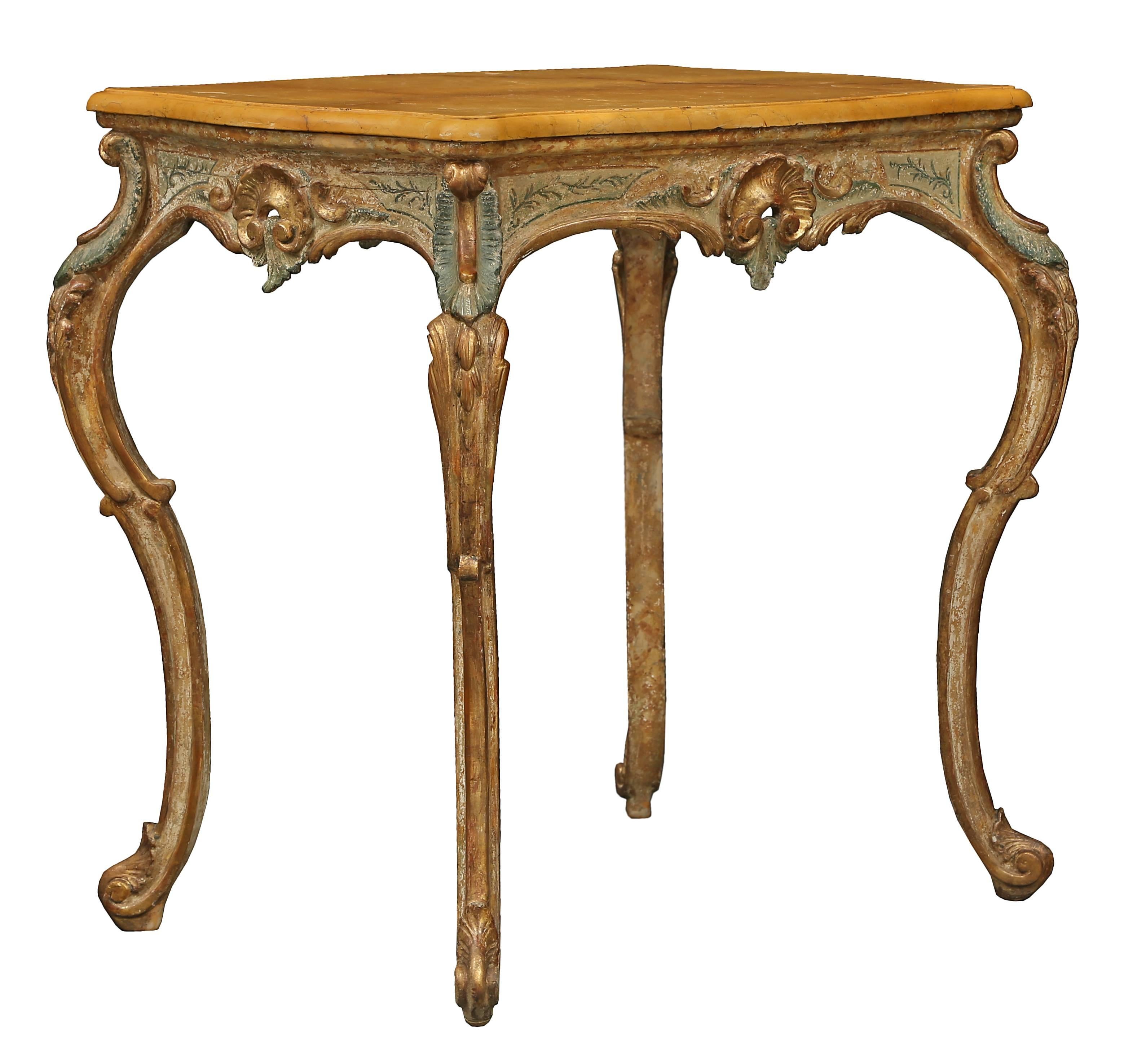 A lovely and very decorative Italian 18th century Louis XV period patinated side table. The side table with all original paint is raised on elegant slender carved cabriole legs with accents of giltwood acanthus leaves. At each side of the scrolled