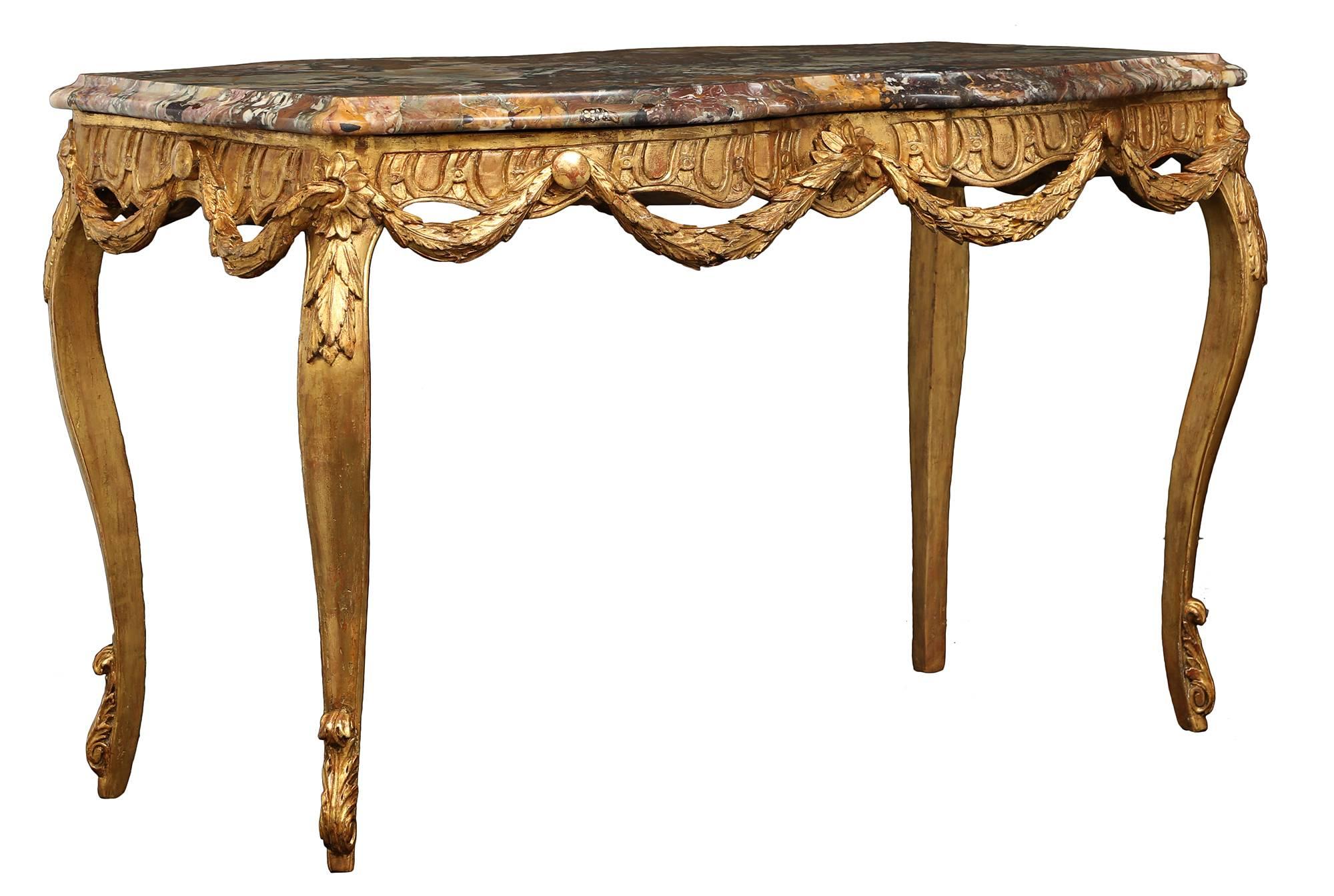 An elegant Italian 18th century Louis XV period giltwood and marble center table. The table is raised by slender cabriole legs with carved acanthus leaves. The intricate scalloped frieze is decorated with charming floral rosettes reserves at the