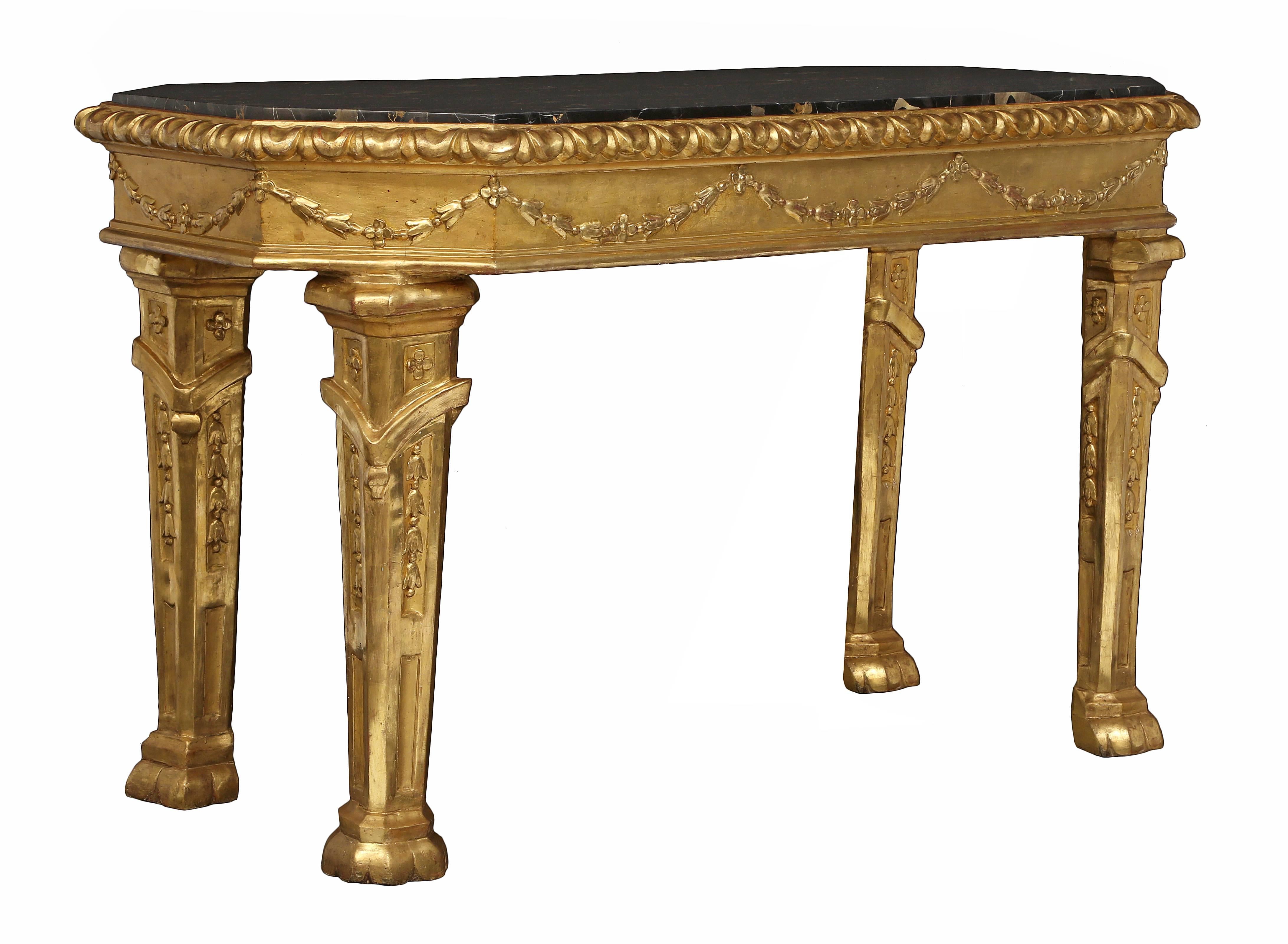 A most handsome and stately Italian 18th century Louis XIV period giltwood and marble Roman console. The freestanding octagonal console is raised by handsome robust legs, with decorative feet and richly carved recessed panels and fitted floral