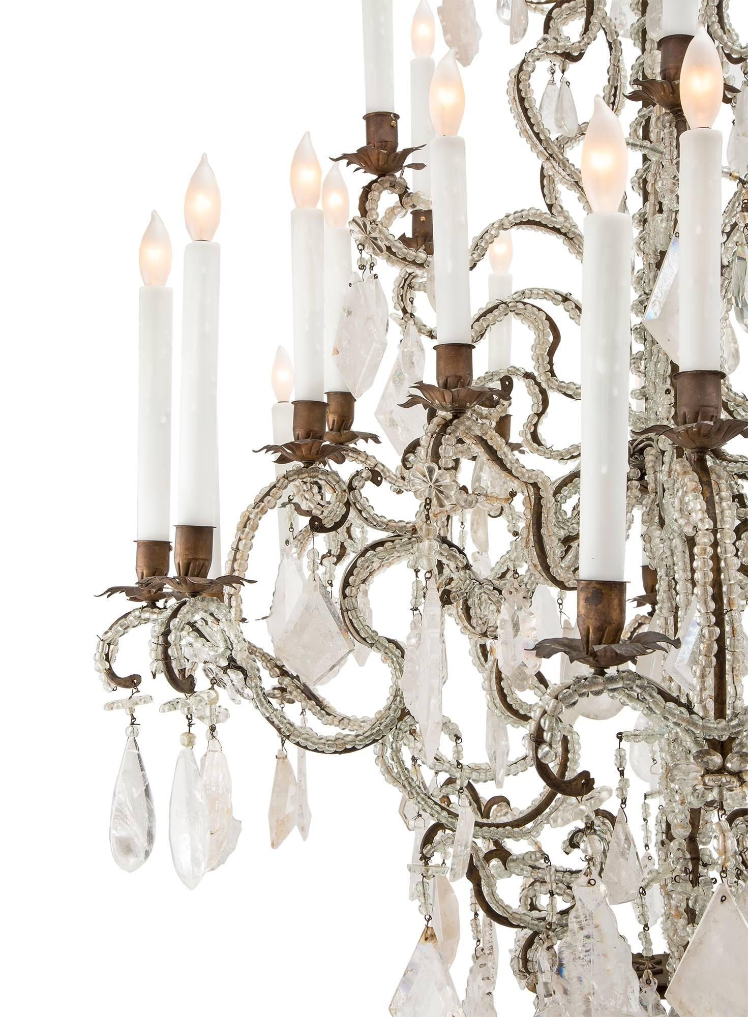 A sensational and large-scale Italian mid-18th century Louis XV Period rock crystal thirty light chandelier. The chandelier is centred by a most impressive solid rock crystal ball amidst fabulously cut rock crystal pendants. Each of the elegantly