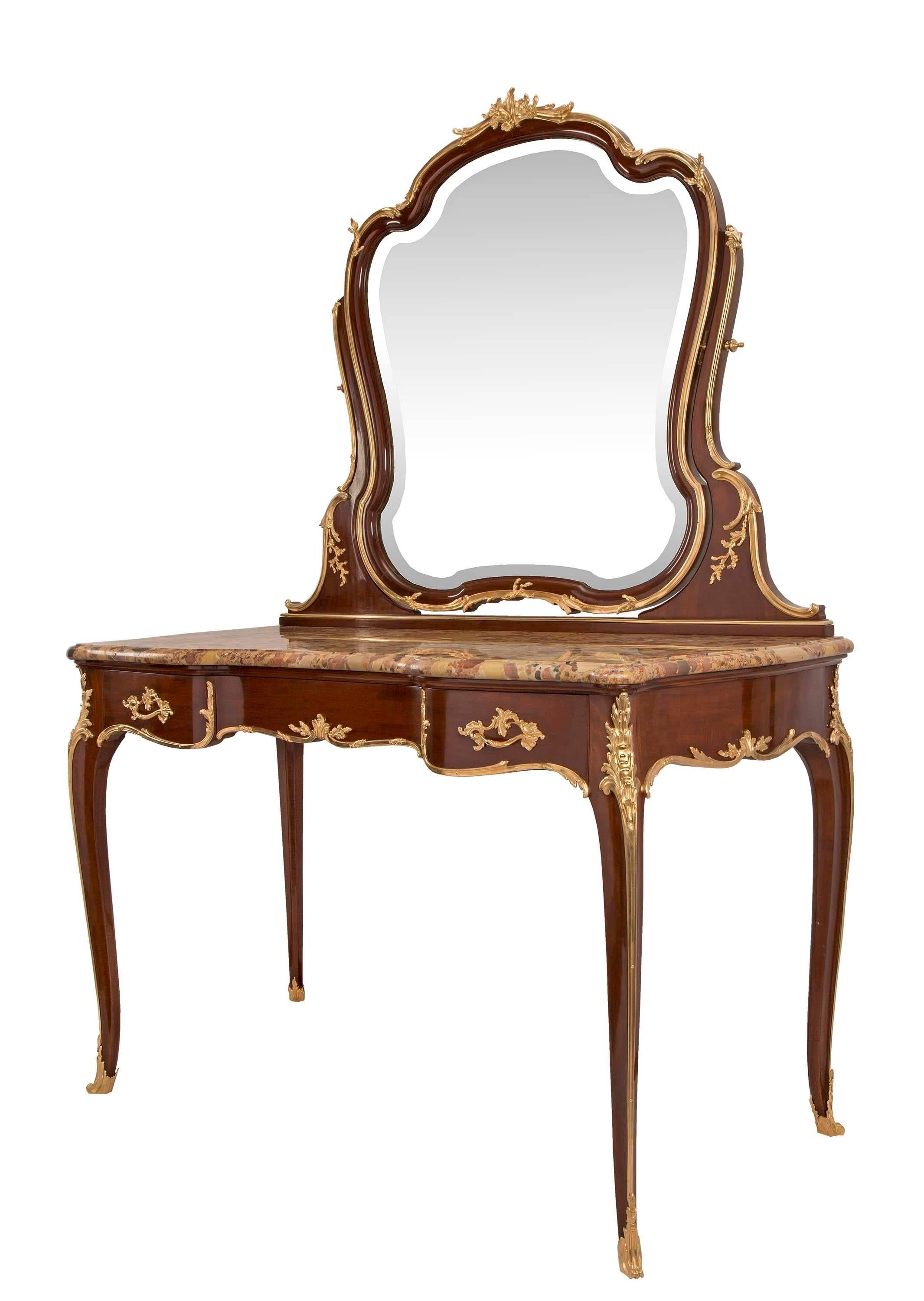 A magnificent and very high quality French 19th century Louis XV style mahogany and ormolu vanity, signed F. Linke. Raised on elegant cabriole legs with ormolu wraparound sabots and chutes continuing up to large acanthus leaf ormolu top mounts. At