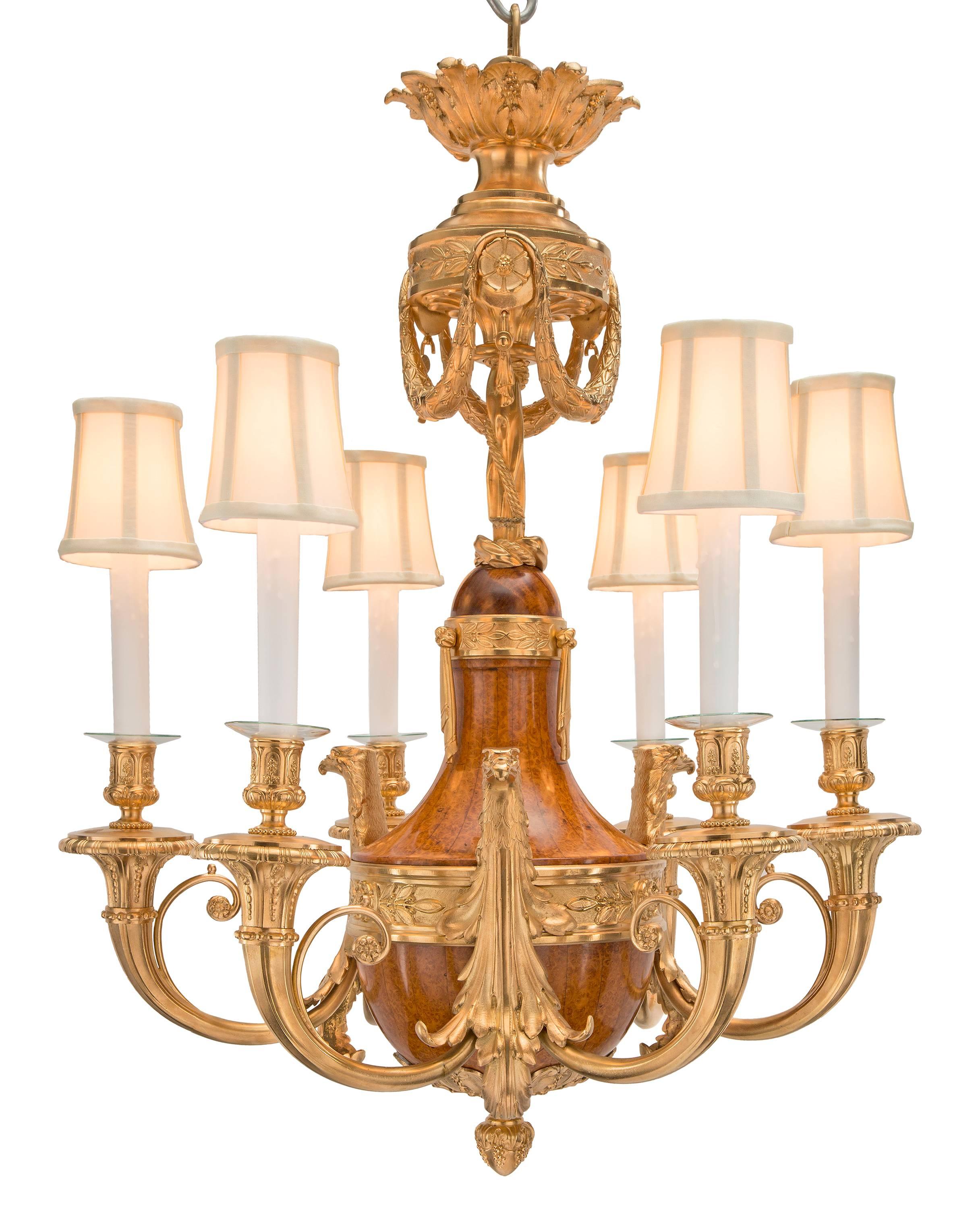 A wonderful and most unique French 19th century neoclassical st. burl walnut and ormolu six-arm chandelier. The elegant chandelier is centered by a richly chased inverted ormolu bottom final amidst fabulous foliate patterns with a hammered design in
