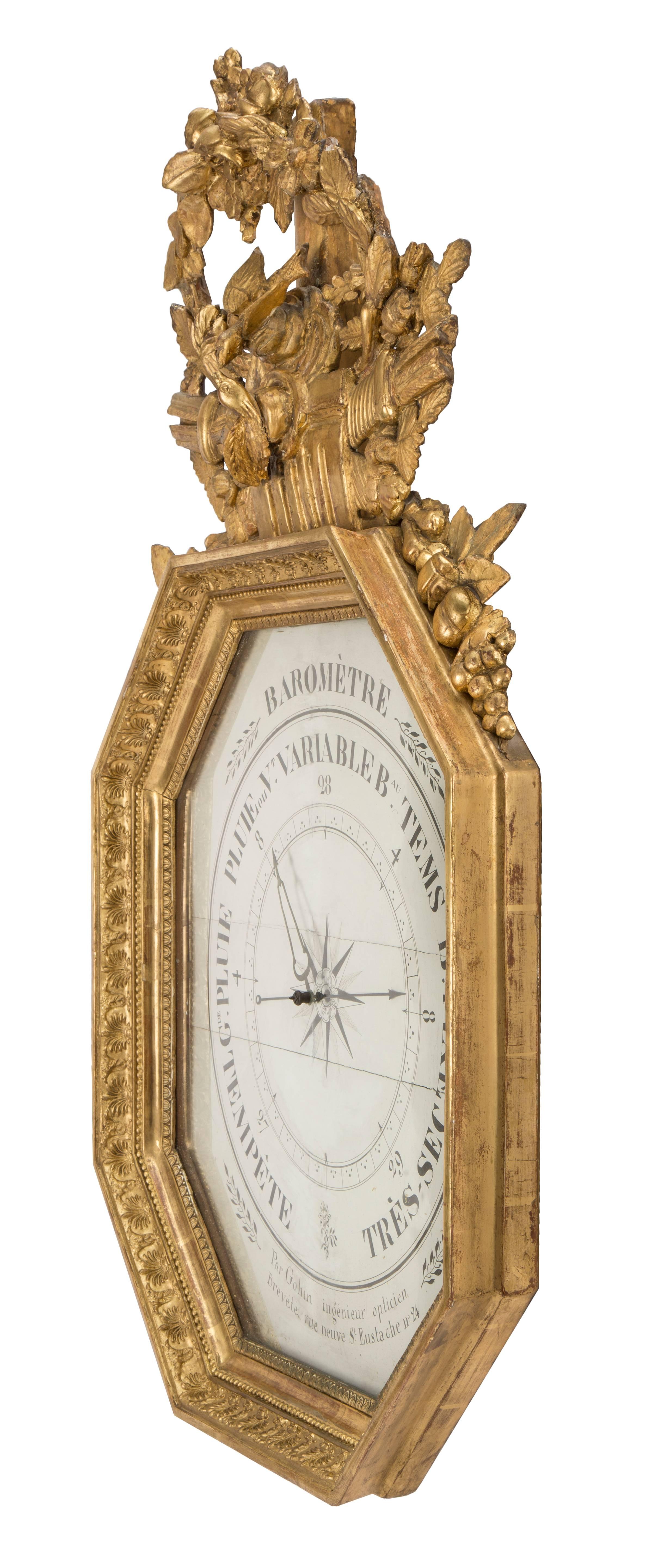 An elegant French 18th century Louis XVI period giltwood barometer signed Gohin. The barometer is framed within an octagonal border with finely carved coeur de rai, beaded and intricate individual patterns. The white background displays the French