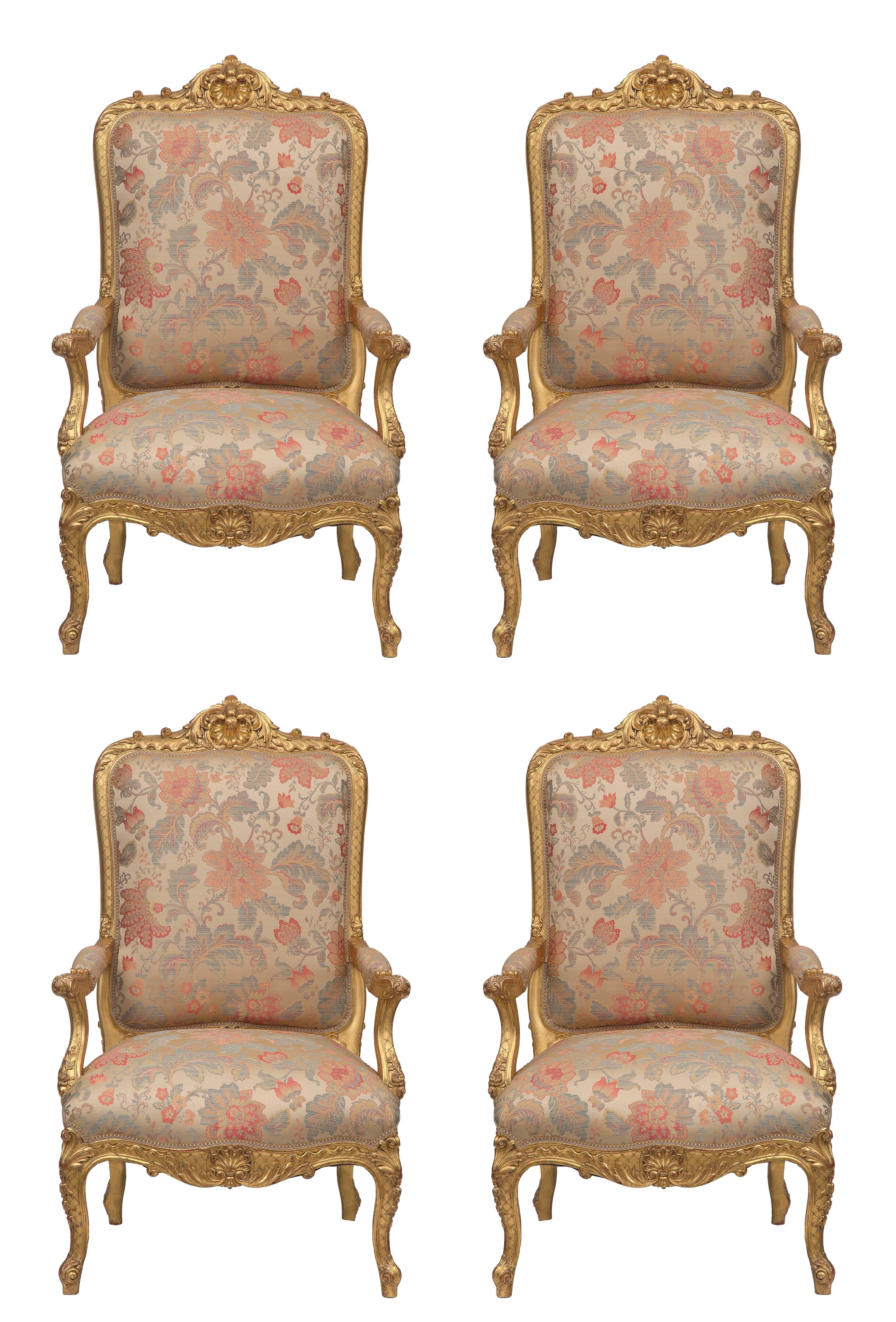 A sensational and large scaled set of four French 19th century Louis XV St. giltwood high back armchairs. The set are raised by handsome and richly carved cabriole legs with an elegant lattice designed background and large acanthus leaves above and