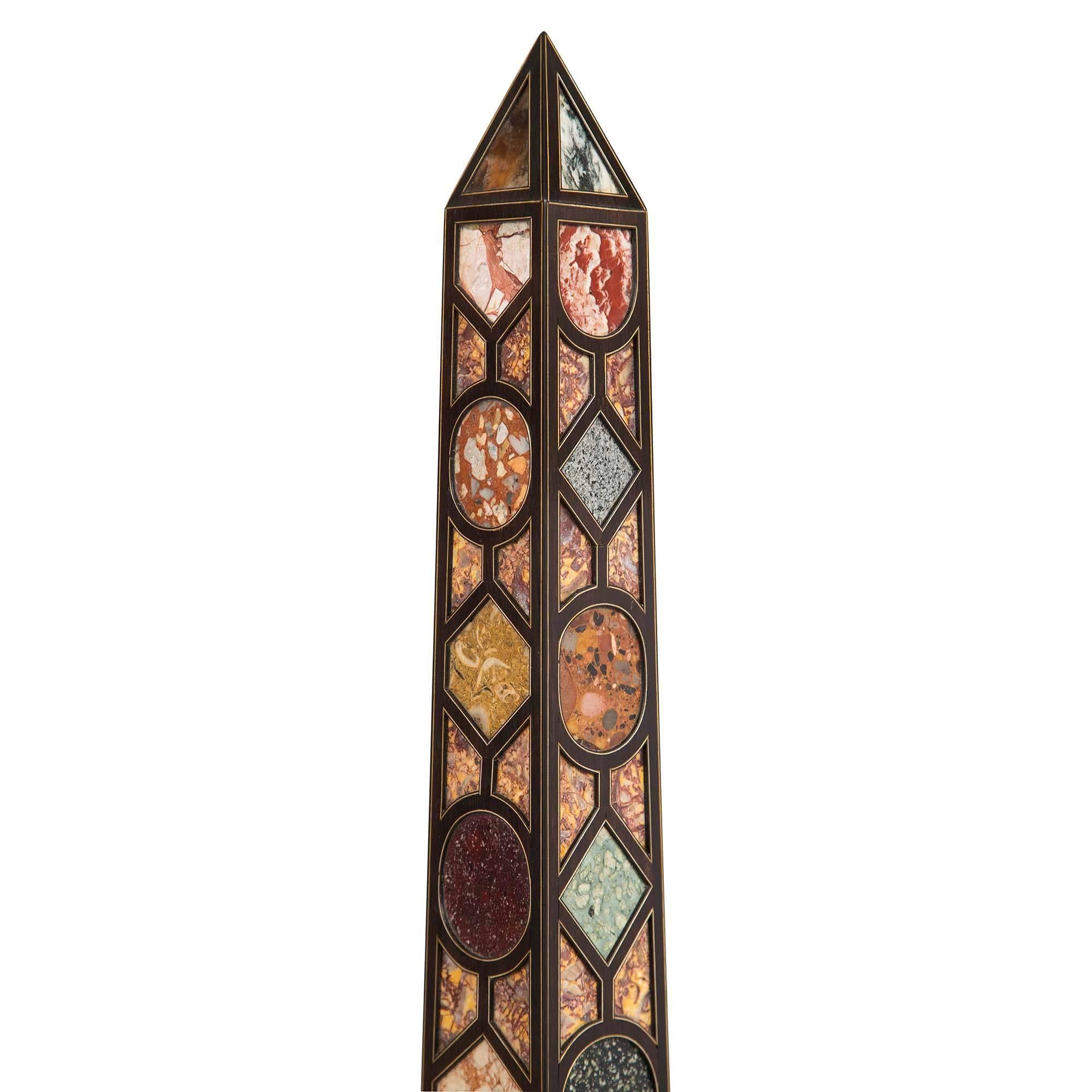 A stunning and large-scale pair of French 19th century Napoleon III period ebonized fruitwood and pietra dura inlaid obelisks. Each obelisk is raised by a square base with a mottled border below striking diamond-shaped and triangular inlaid