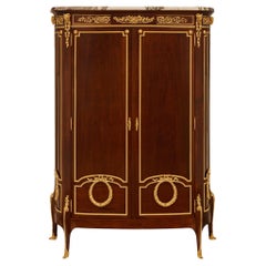 Armoire française du 19ème siècle de style transitionnel en acajou et bronze doré, signée Linke