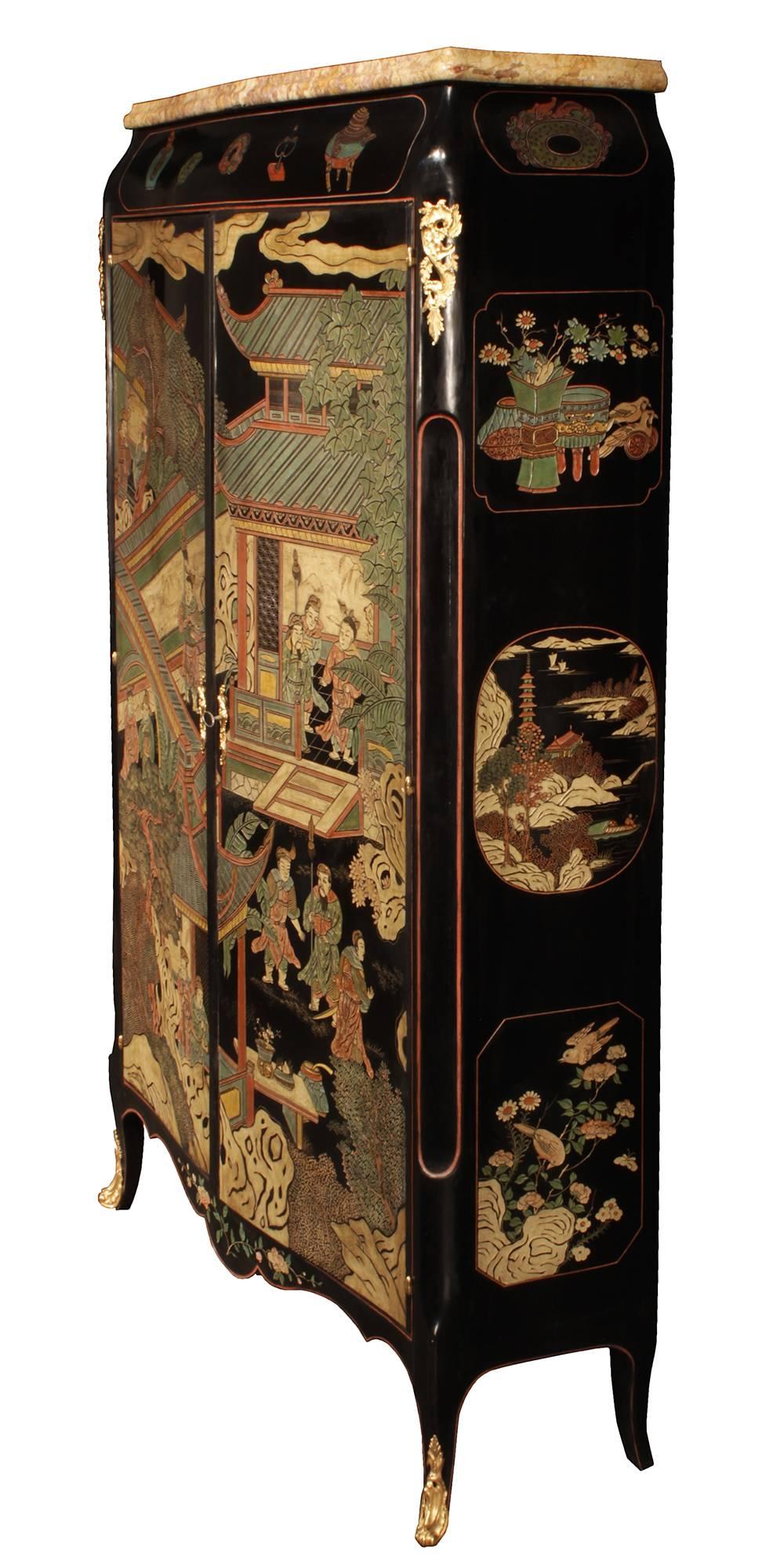 A stunning 19th century French Louis XV st. Coromandel and ormolu armoire. The armoire is raised by four elegant cabriole legs with richly chased pierced ormolu sabots and a unique inlaid red filet leading along the scalloped frieze that is centered