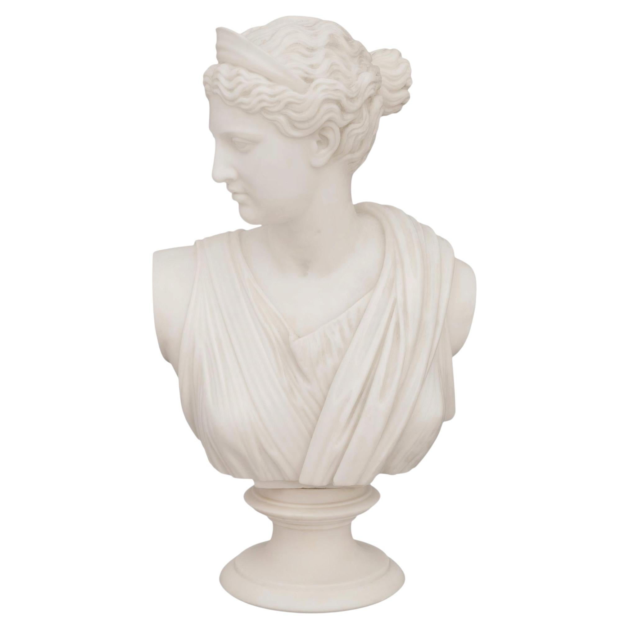 An Italian mid 19th century Grand Tour Period white Carrara marble bust of Diana
