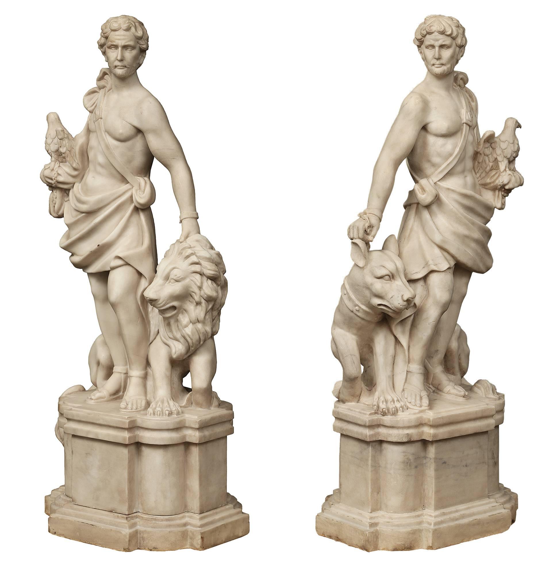An outstanding and handsome true pair of Italian 19th century white Carrara marble statues. Each statue is raised by a rectangular pedestal base with recessed rounded corners and a stepped bottom design. Each statue is of a powerful bearded warrior