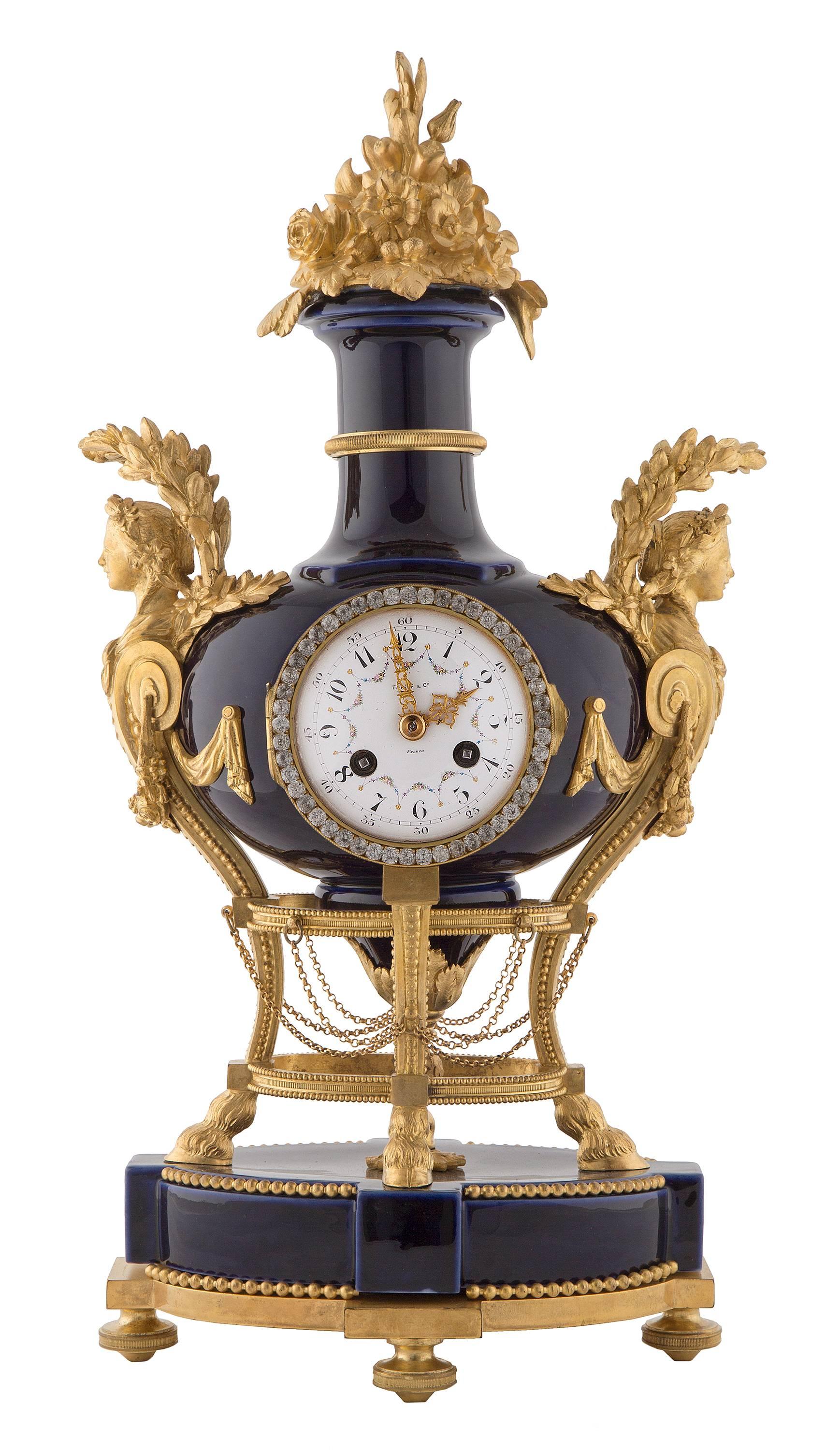 A stunning French 19th century Louis XVI St. ormolu and cobalt blue Sèvres clock by Tiffany & Co. The clock is raised on ormolu topie feet and support with beaded border. The oval Sèvres base is accented by a central ormolu rosette and beaded