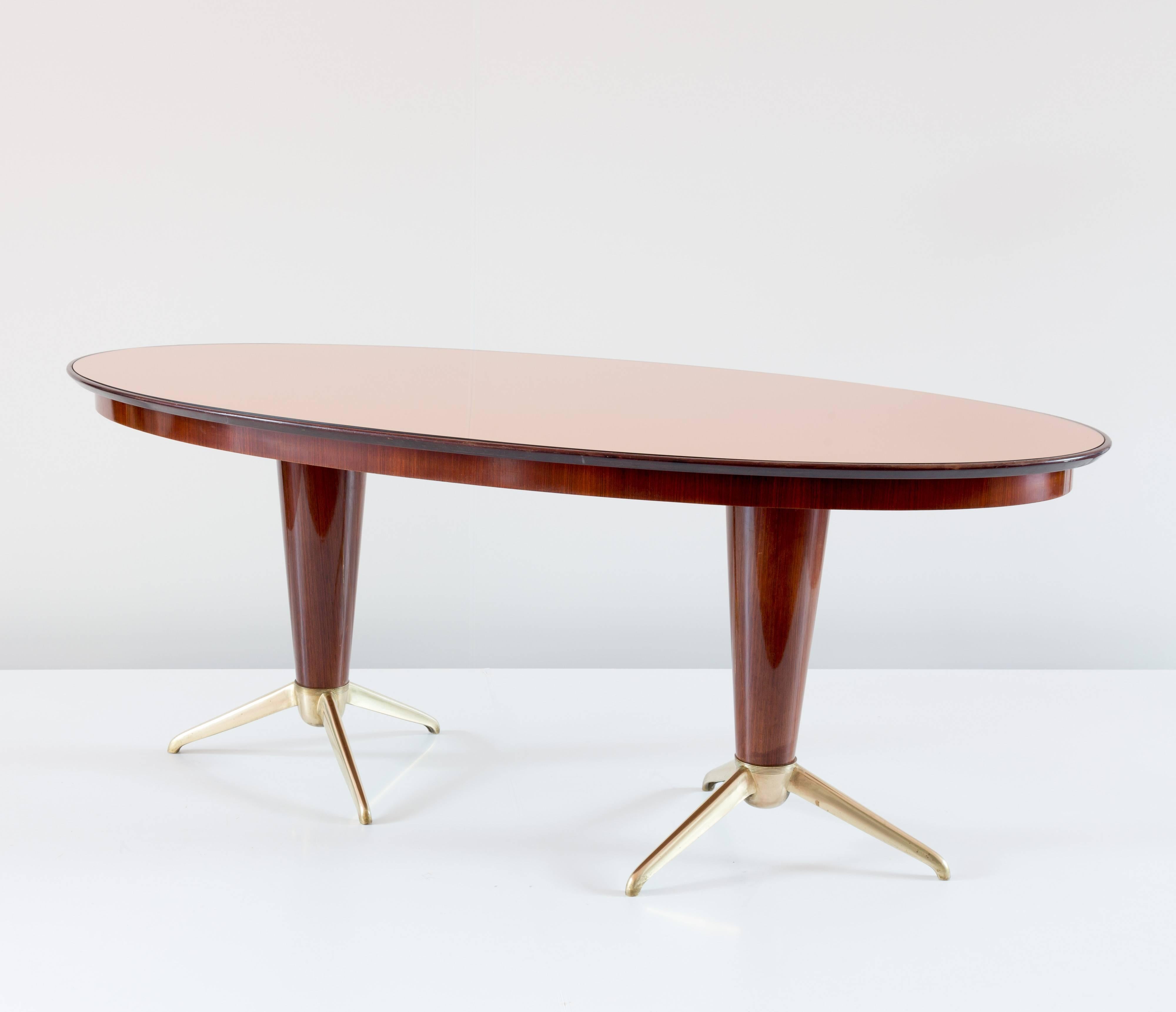 Rare mahogany dining table attributed to Melchiorre Bega, circa 1952
oval top in mirror rose glass, two central feet with six brass legs
mahogany veneer.
Perfect original condition.
Measures: H 78 cm, 195 x 99 cm. 

Literature: Aloi, Esempi di