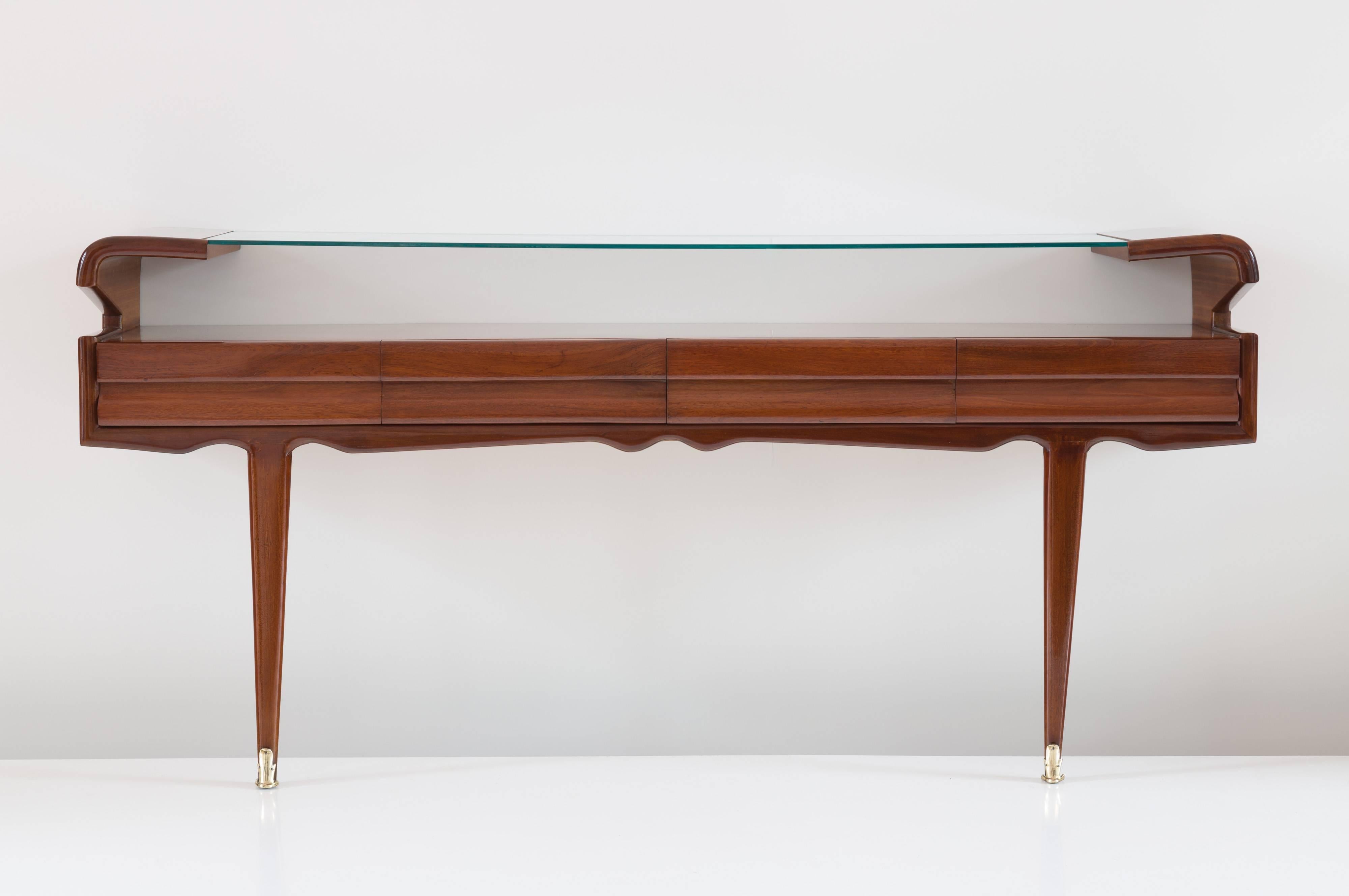 Elegant large console table by Dassi, circa 1950, 
rosewood veneer, glass top, four drawers, brass feet,
rare wood handles, 
perfect original condition.

Measures: H 90 cm, 190 x 40 cm.