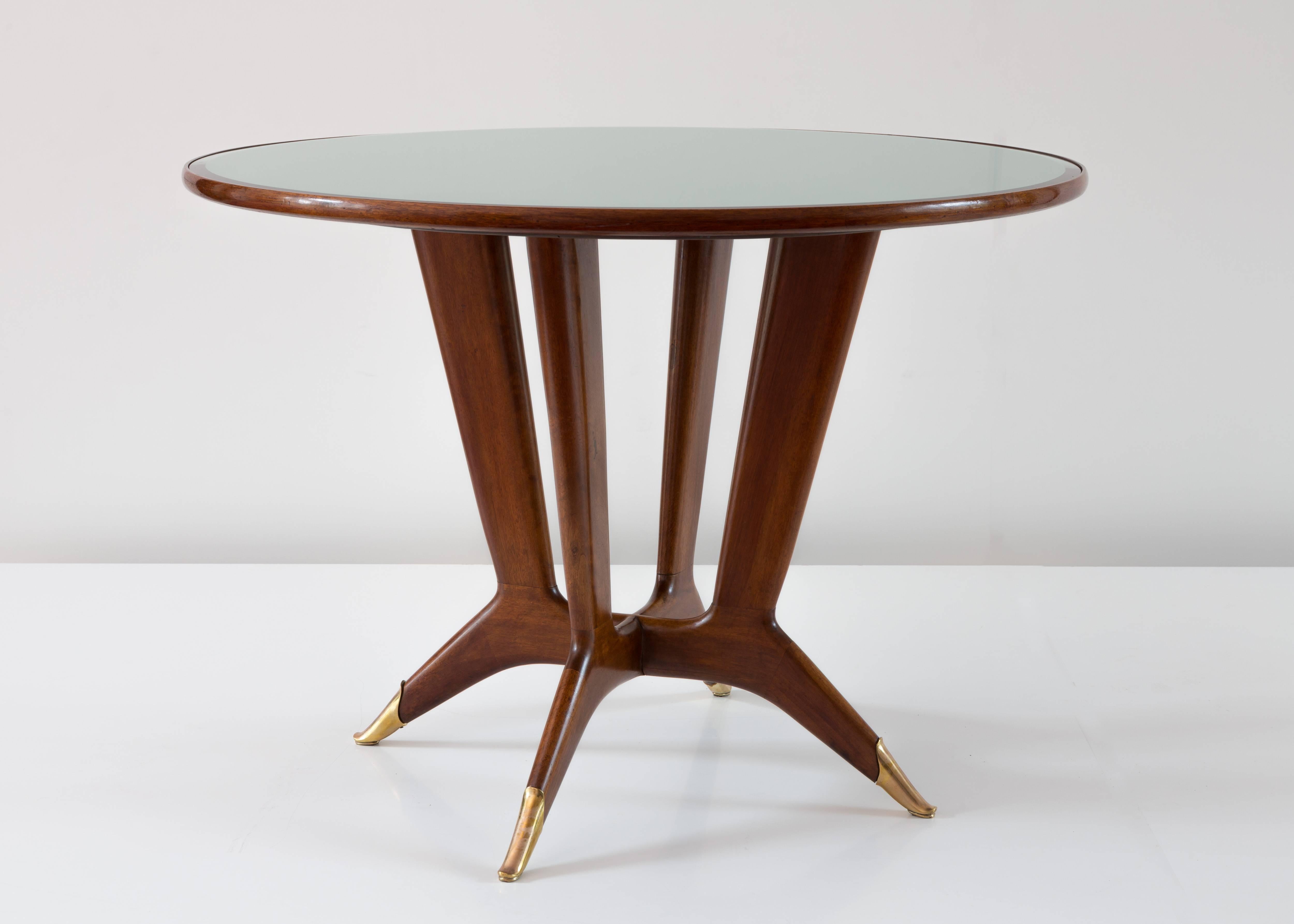 Important and rare round center table by Guglielmo Ulrich, 1940
round top on mirrored glass, brass sabot, four elegant leg
mahogany, brass, mirror
very good condition. 

Measures: Height: 80 cm, diameter 110 cm, top thickness,: 3 cm.