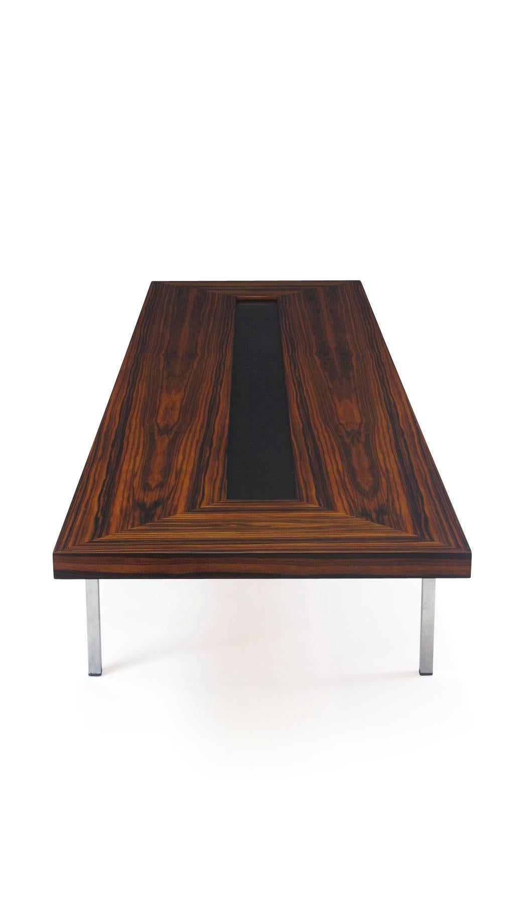 Extra long 1970's Santos Rosewood coffee table with rich grain and recessed black formica in center, raised on chrome legs. Professionally restored and in excellent condition.