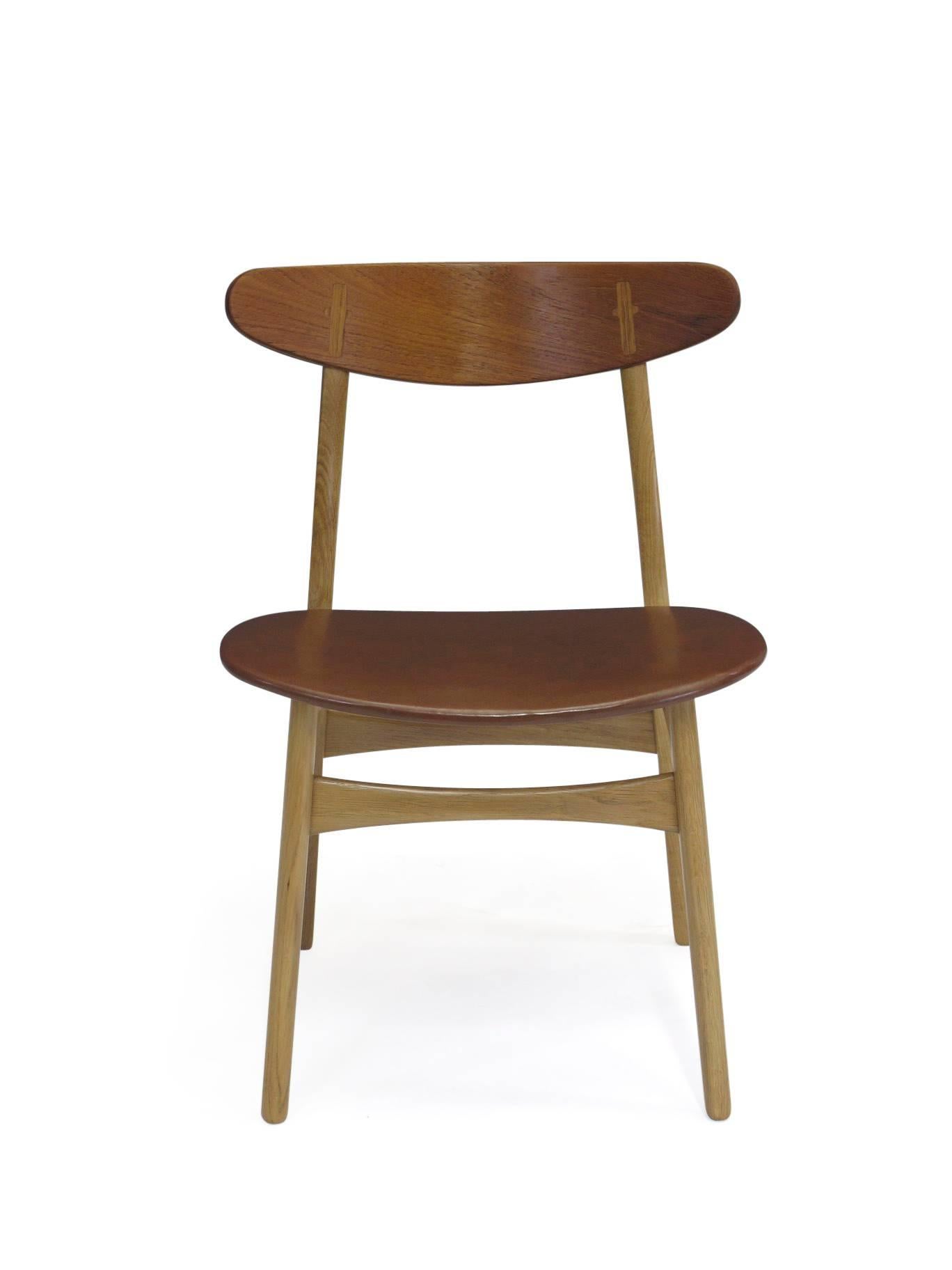 Hans Wegner for Carl Hansen & Sons, model CH30 dining chairs in white oak with teak backs, and vintage brown vinyl seats. The frames have been professionally restored, and in excellent condition.