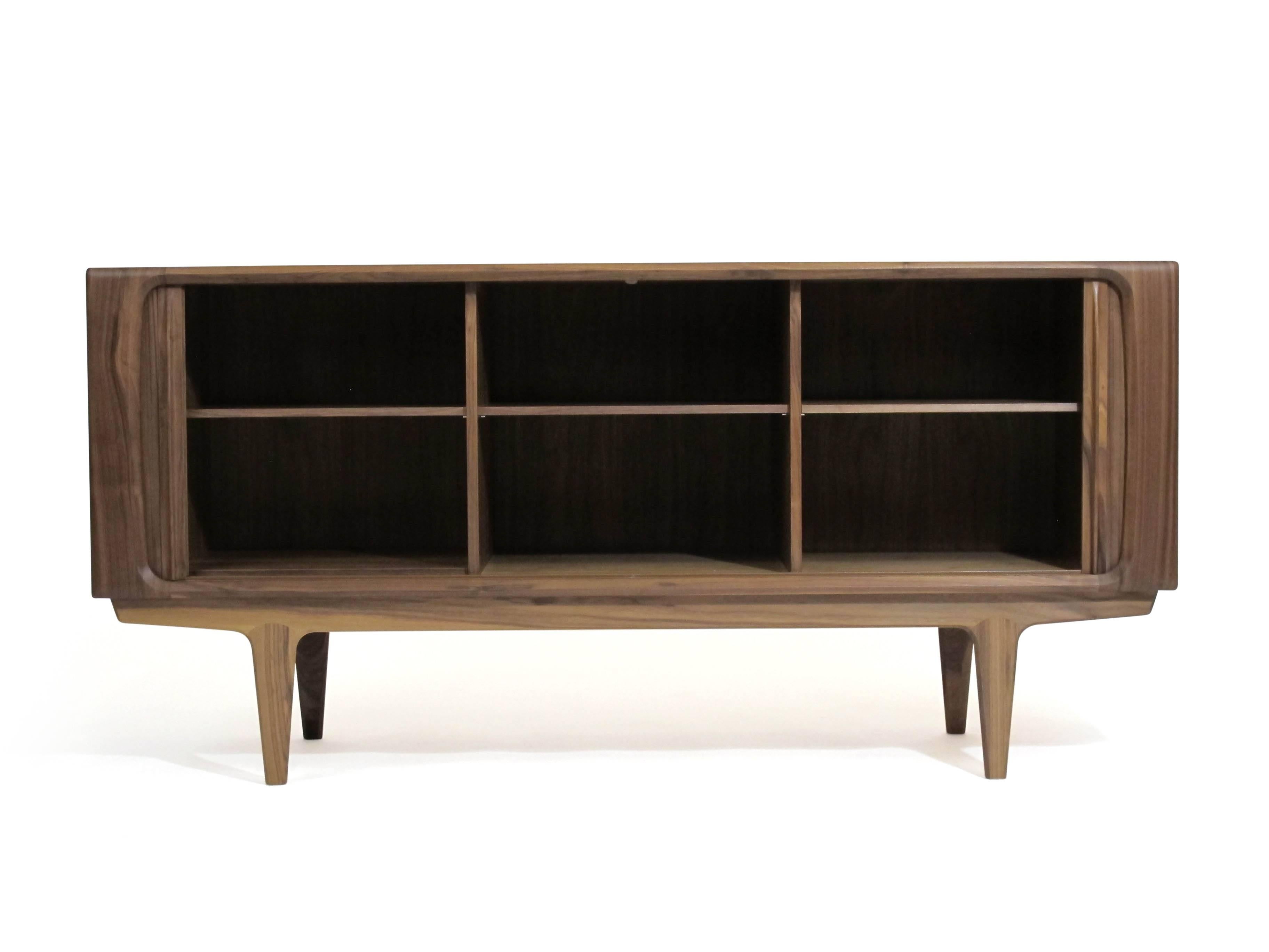 Model 142 sideboard in walnut by Bernhard Pedersen & Son, designed in 1965. Handcrafted of walnut and features tambour doors that roll seamlessly into the back. The interior of the cabinet is beautifully finished with adjustable shelves on each side