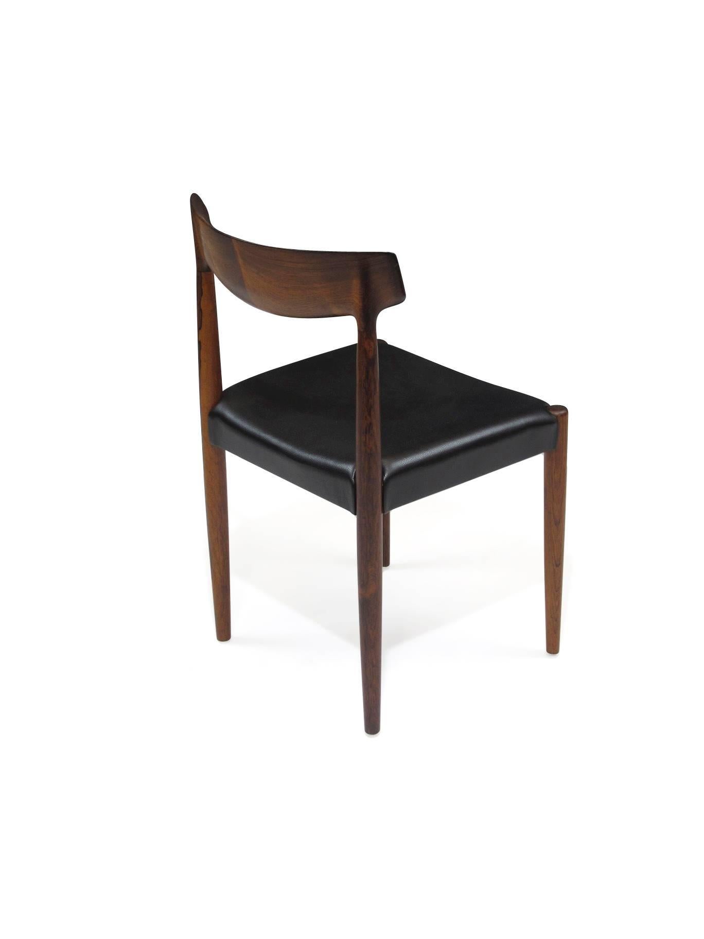 Six Mid-Century Brazilian rosewood dining chairs designed by Knud Faerch for Slagelse, Denmark, model #343. Exquisite solid rosewood with hand-carved backs, finely joined in centre for book-matched effect. Professionally restored and upholstered in