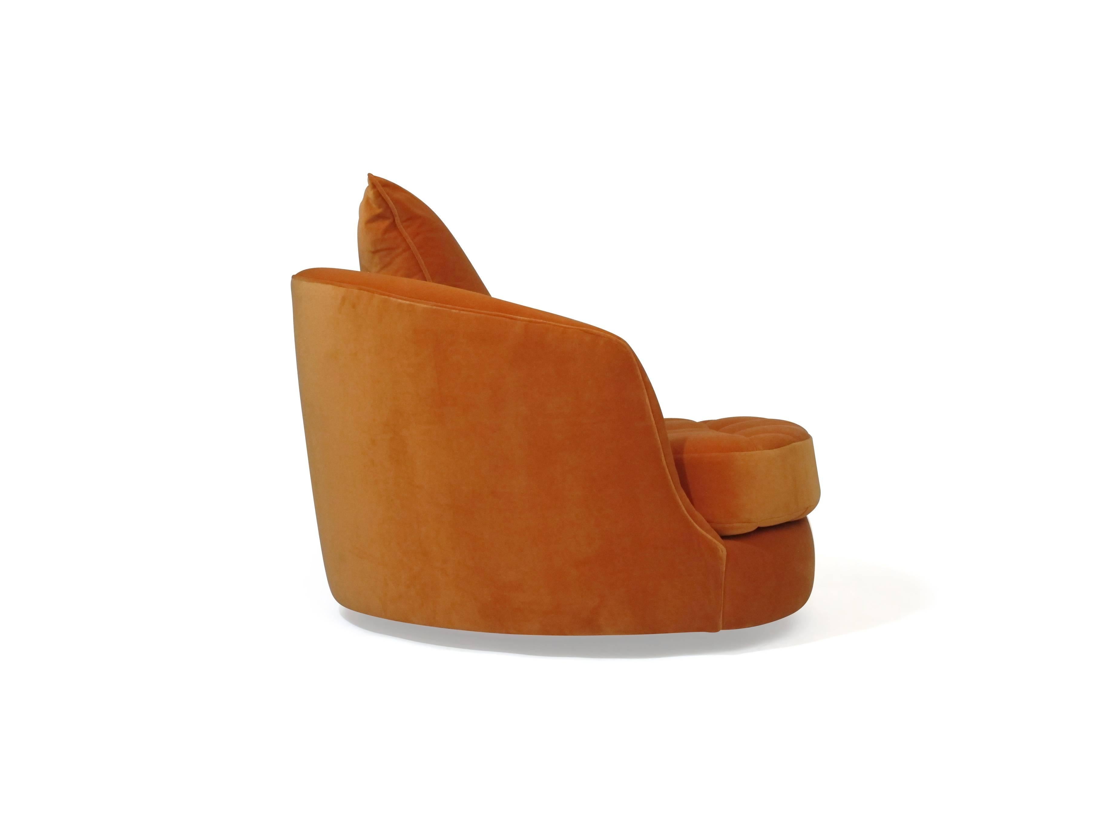 Swivel lounge chair designed by Milo Baughman for Thayer Coggin in orange velvet. 
Ottoman measures: W 36, D 24, H 14 in.