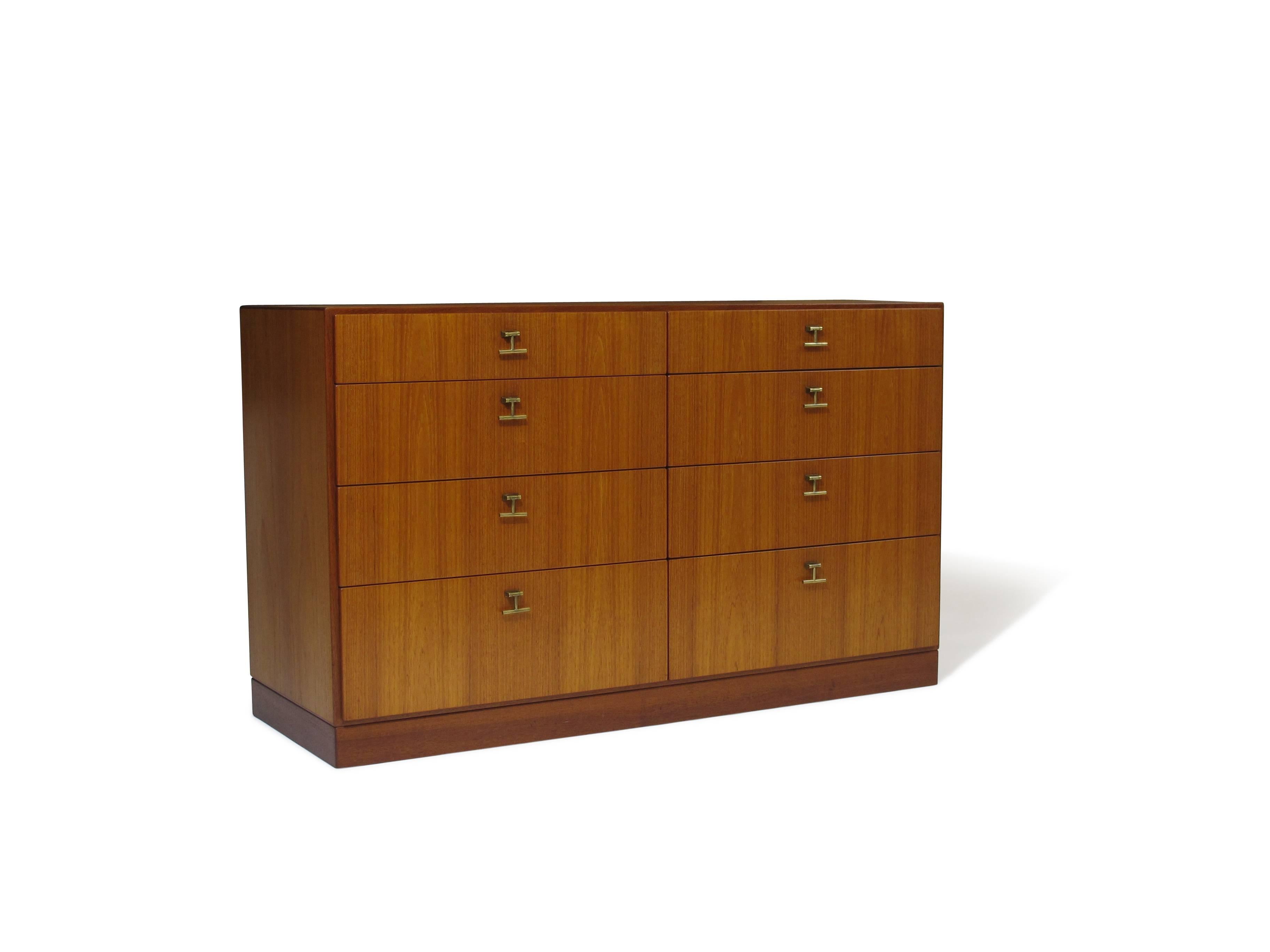 Borge Mogensen eight-drawer teak dresser with brass pulls on plinth base manufactured by CM Madsen for FDB mobler.