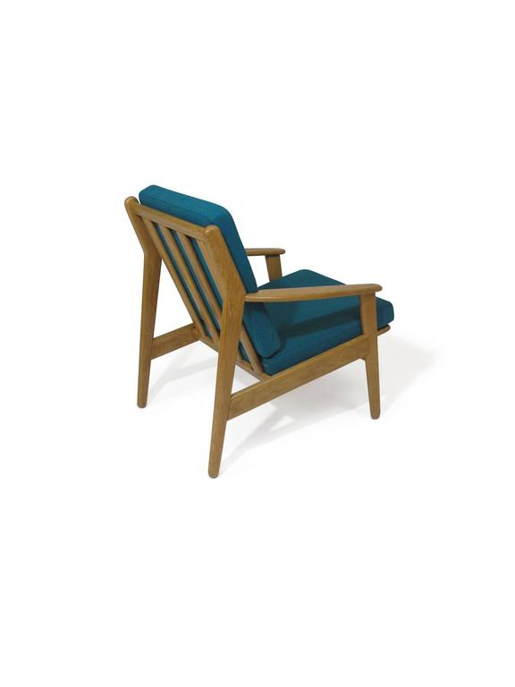 Danish lounge designed by Poul Volther crafted of a solid white oak frame, newly upholstered in a teal wool fabric. Finely restored in a excellent condition.