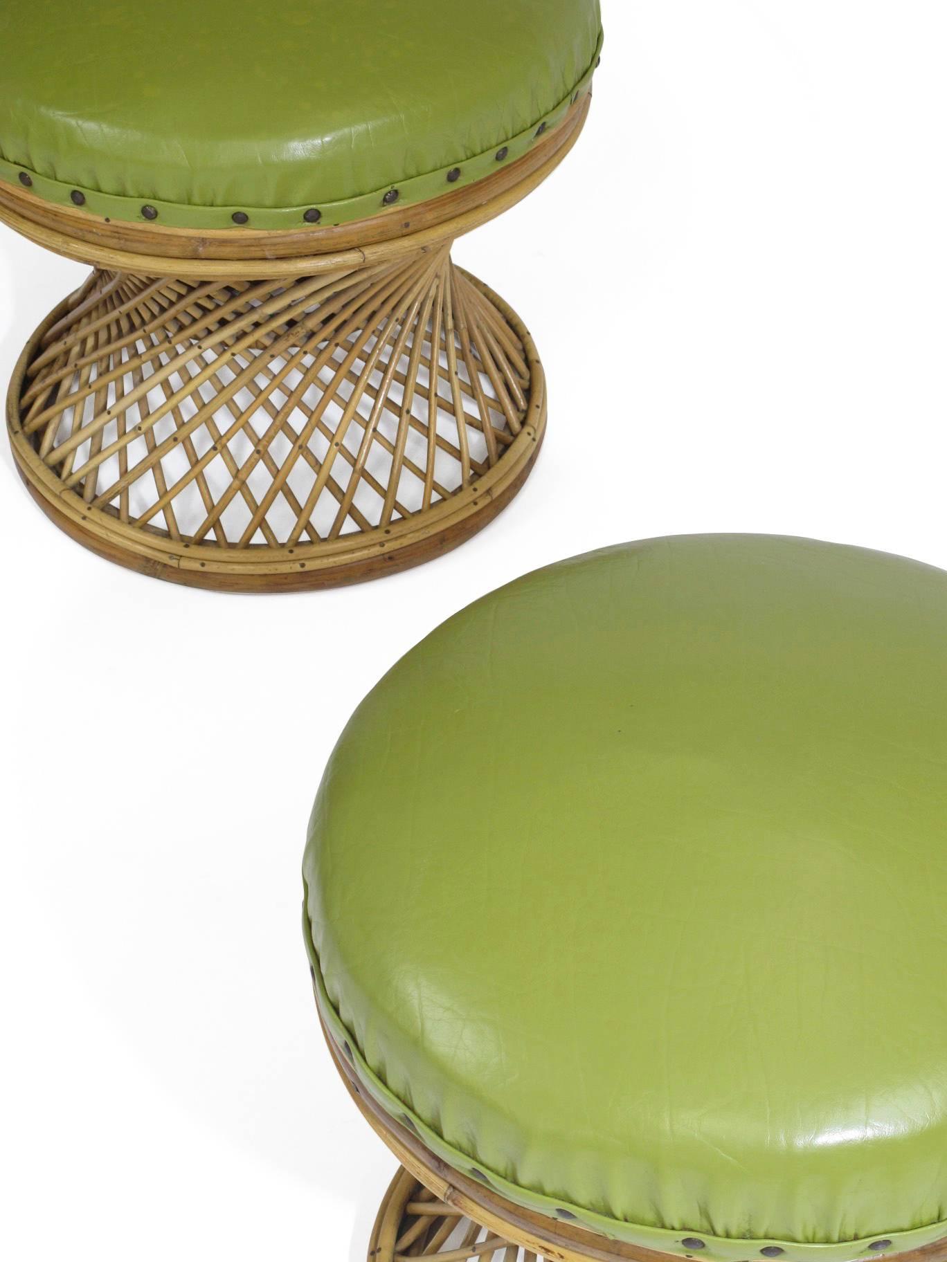 Pair of Mid-Century rattan ottomans in original green vinyl with tack edging. Upholstery options available upon request. 

       