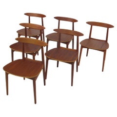 Sillas de comedor danesas de teca con asientos de madera