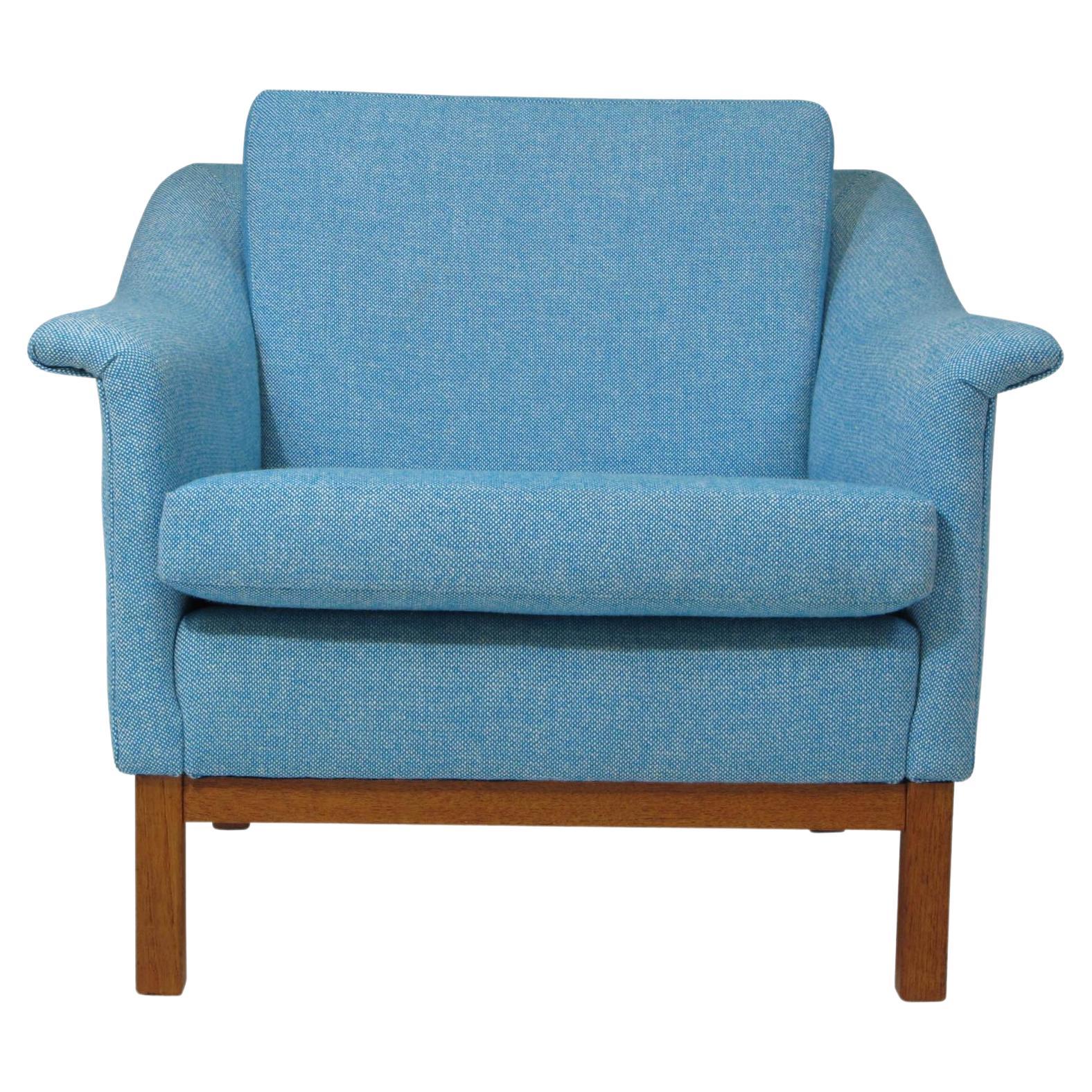 Mid century lounge chair designed by Folke Ohlsson for Dux. Solid wood frame newly upholstered in woven light blue & white Nanna Ditzel wool textile. 
 