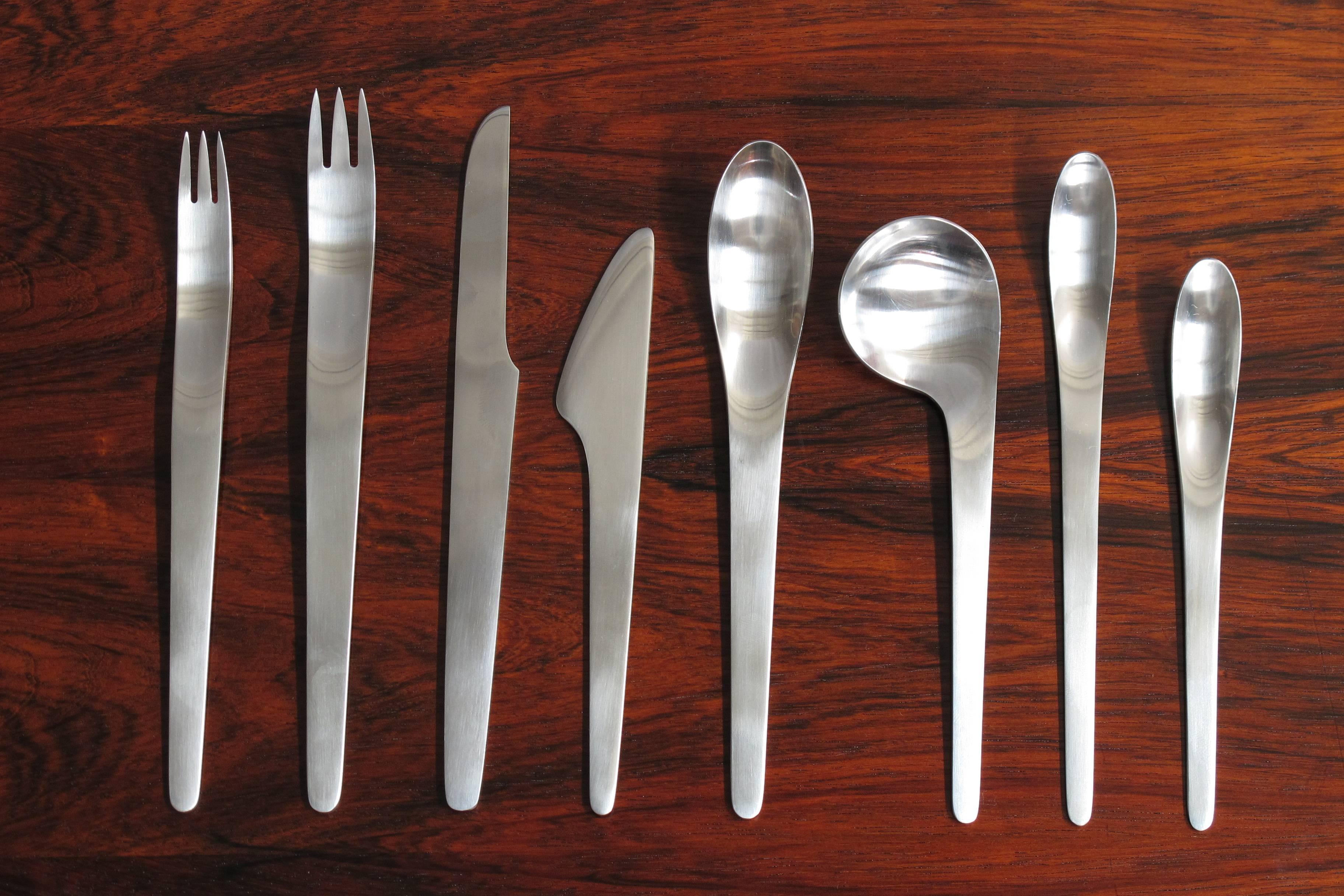 Stainless flatware service for eight designed by Arne Jacobsen, model '660' flatware was designed for use in the Royal Copenhagen Hotel in 1957 and initially manufactured by A. Michelsen. This is a complete set of 77 pieces. Each piece wrapped in A