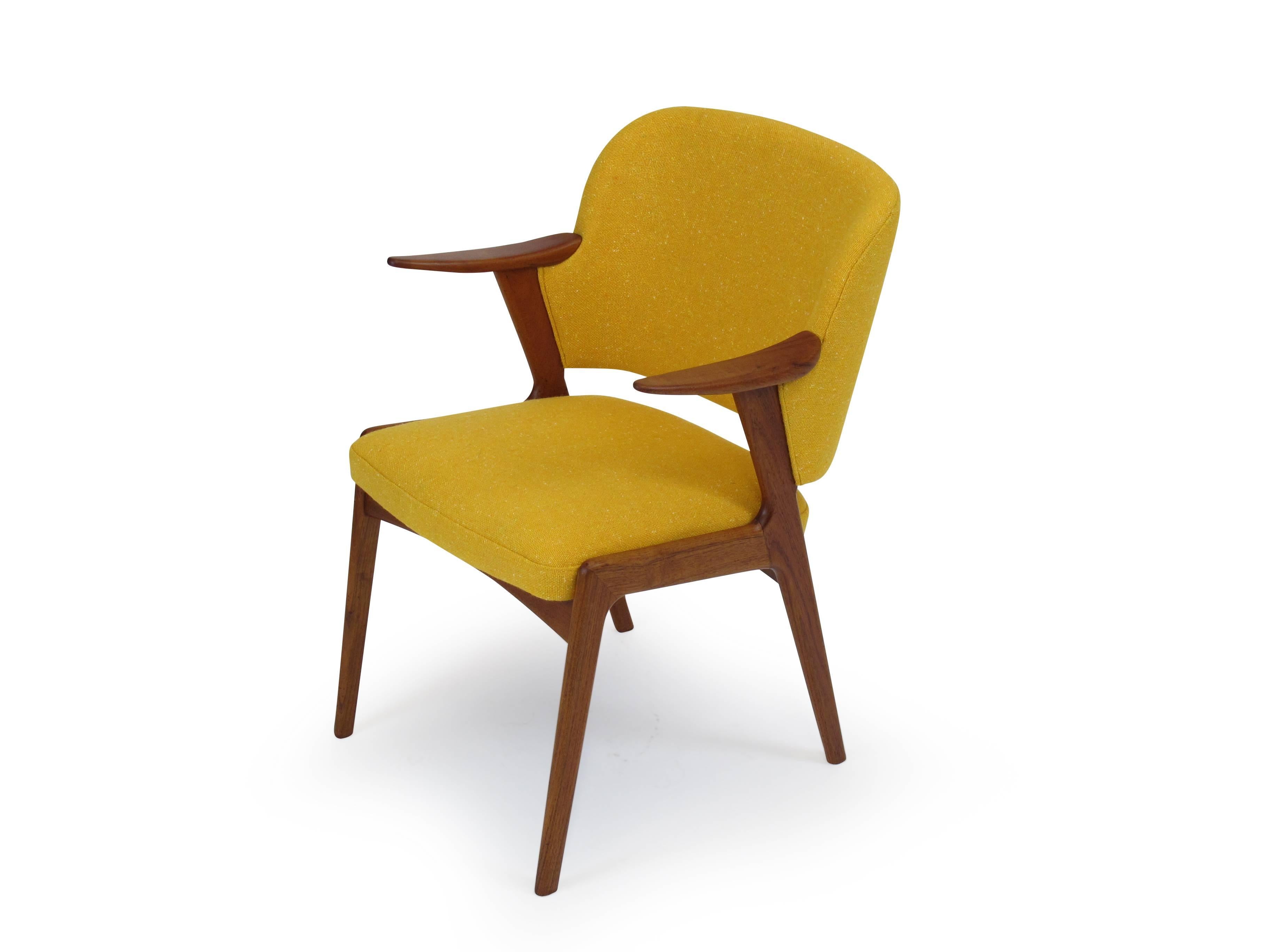 Finley restored midcentury Danish armchair in manner of Kurt Ostervig. Solid teak frame with an upholstered curved back with excellent back support and sculpted teak armrests; newly upholstered in a high-quality yellow wool textile. Fabric swatch