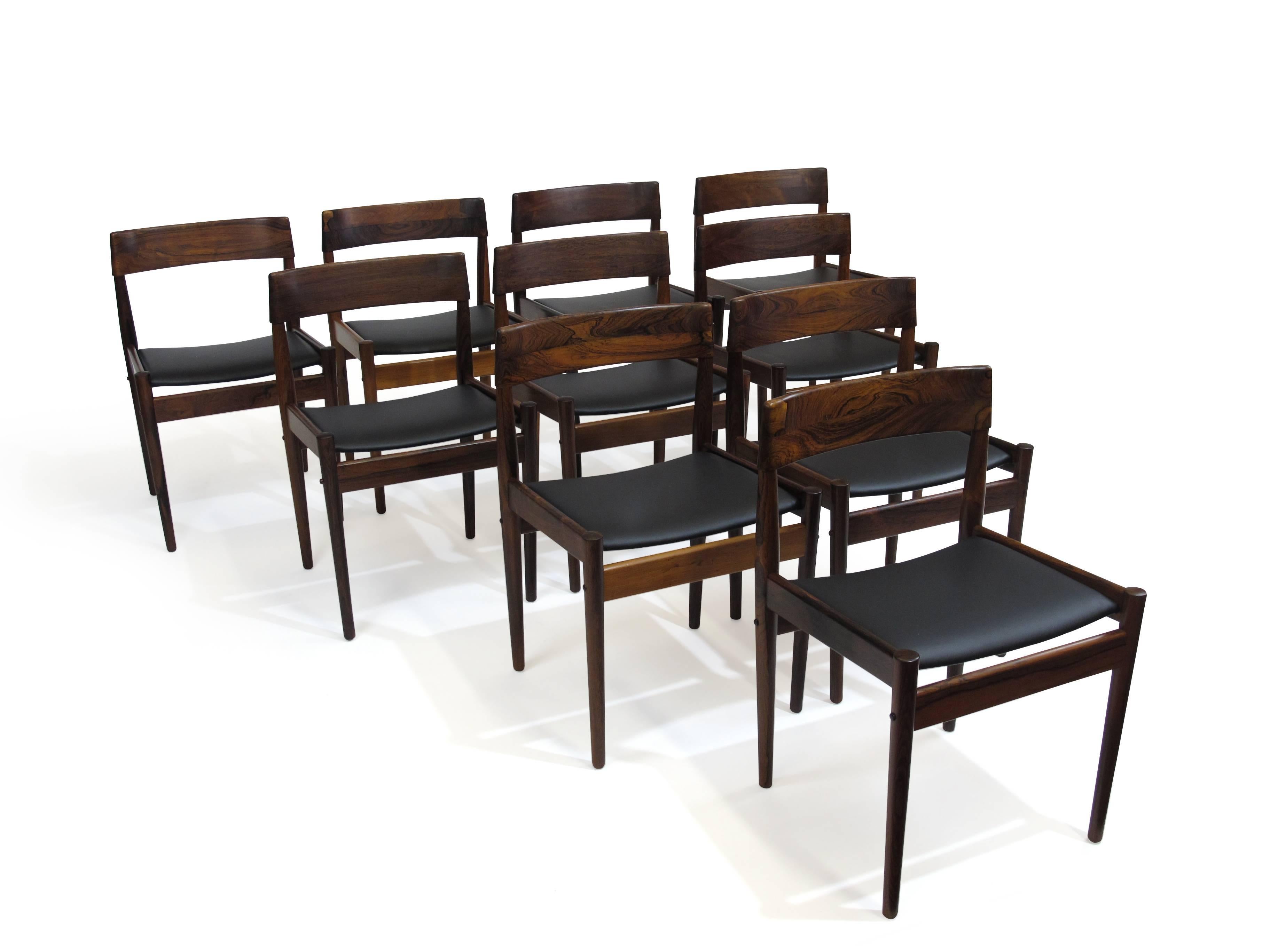 Exquisite set of ten solid Brazilian rosewood dining chairs designed by Grete Jalk for P. Jeppesens in 1961. Model P J 3-2 features hand sculptured back rests of solid Brazilian rosewood which is dark has has rich dynamic grain patterns. Newly