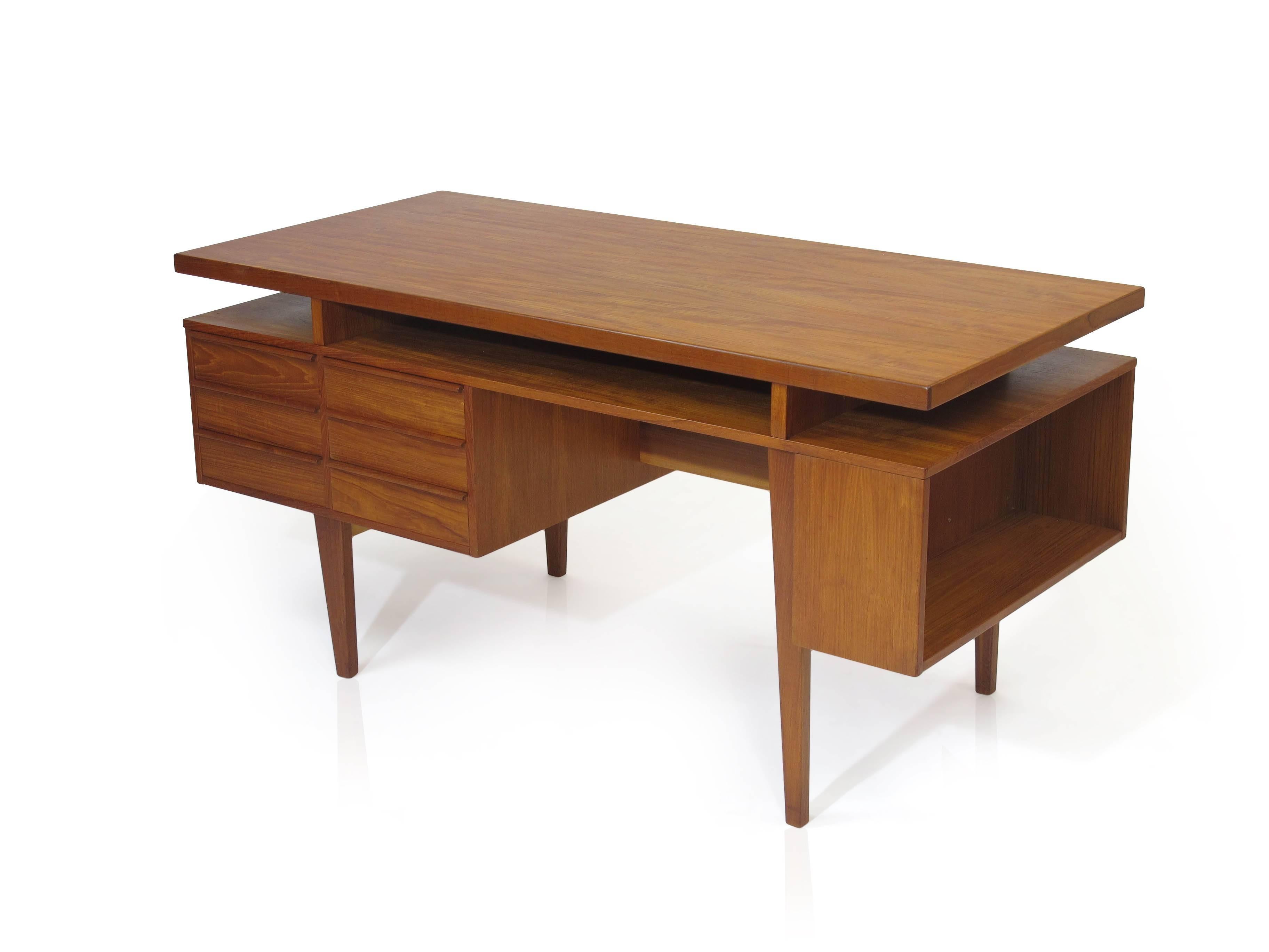 Danish teak desk with six drawers, book shelf on back and right side.