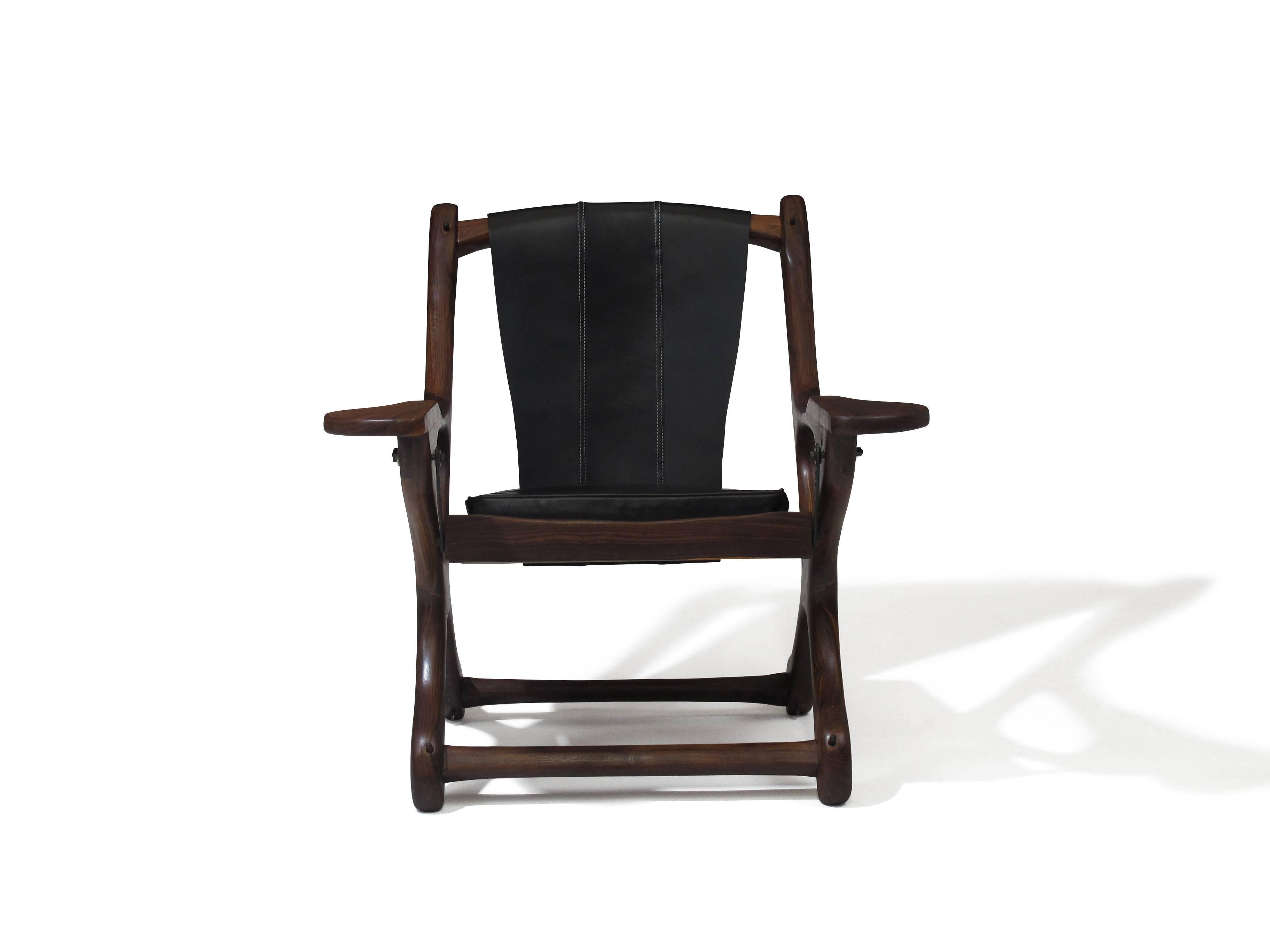 Swinger rosewood chair designed by Don Shoemaker. Solid cocobolo rosewood frame with doweled joints, handcrafted in Mexico, late 1950s. Newly restored and upholstered in black leather.