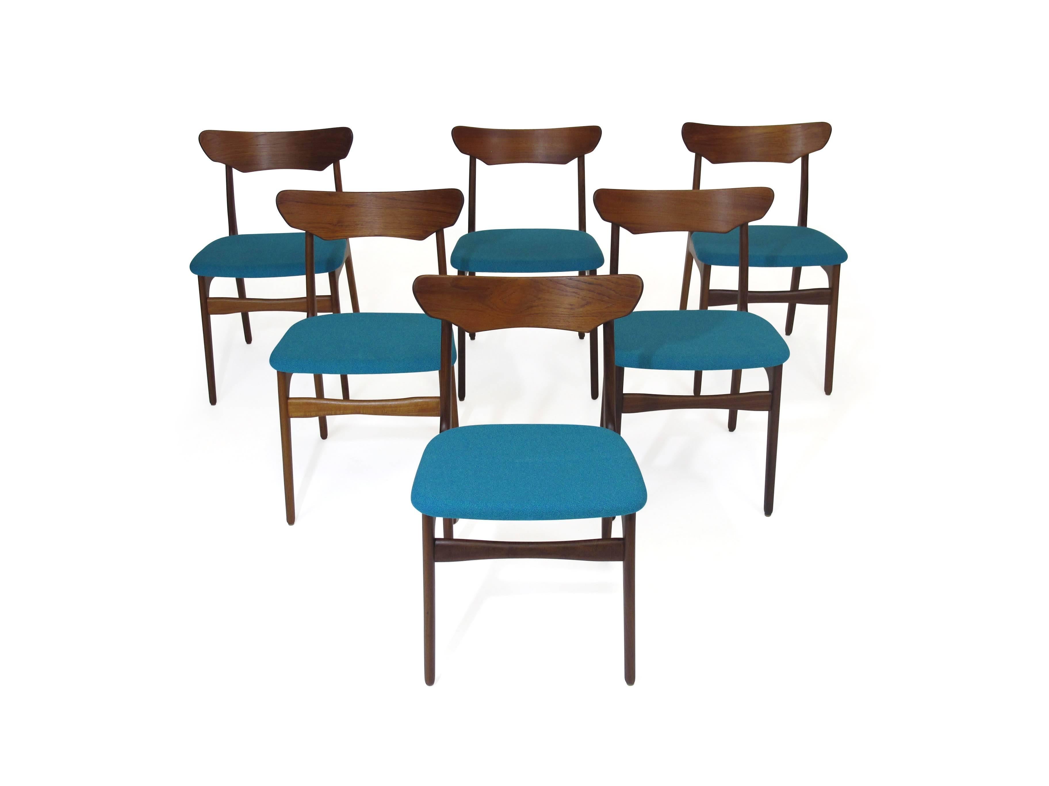 Six Mid-Century dining chairs designed by Schionning and Elgaard for Randers Mobelfabrik. Solid teak wood frames with newly upholstered seats in a teal wool fabric. Additional chairs and upholstery options available upon request.

 