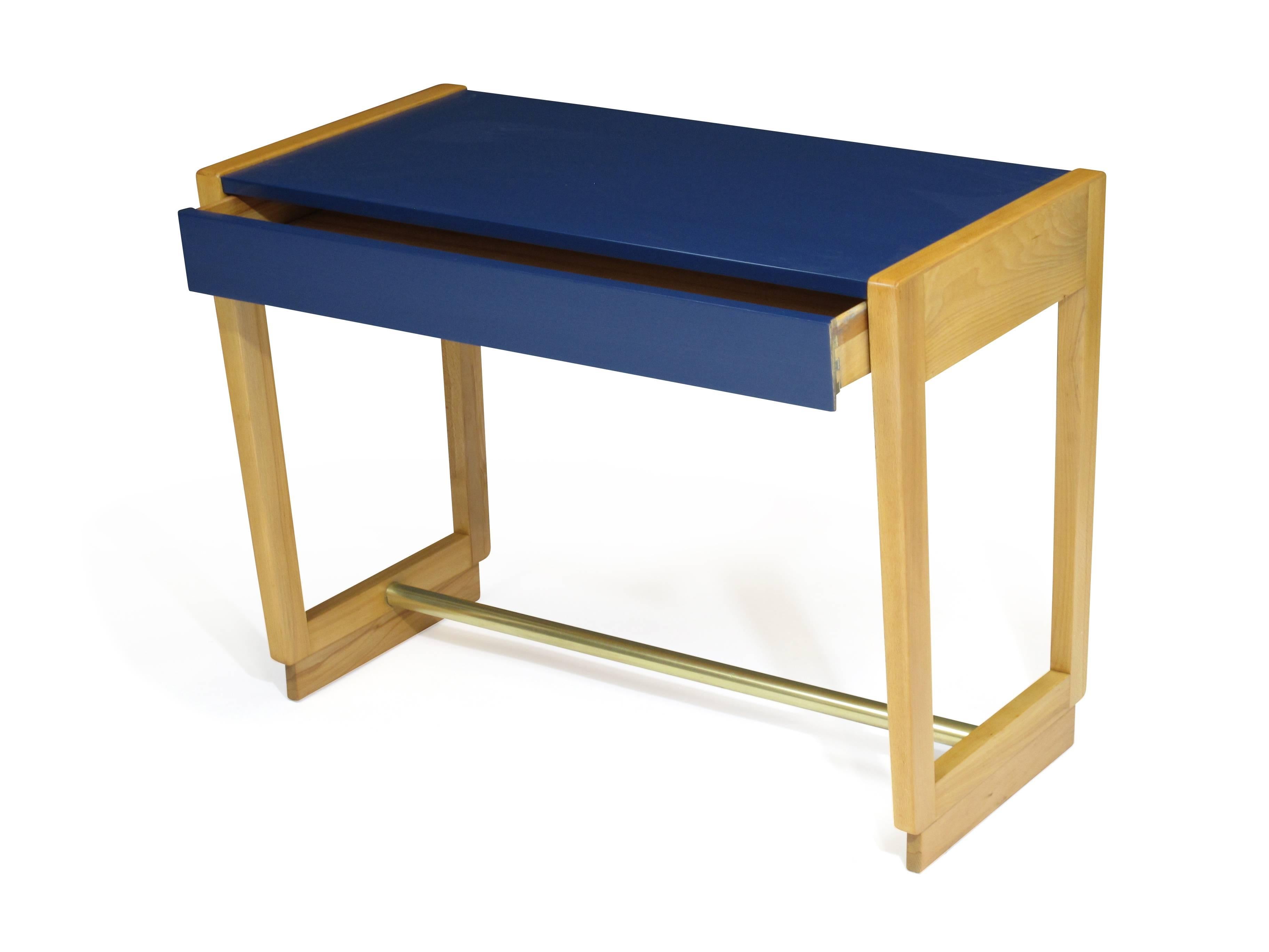 Midcentury single drawer entryway console table in beech with brass stretcher designed by Edward Wormley for the Drexel Precedent Collection, circa 1947. Newly restored with the color block of navy blue lacquer.