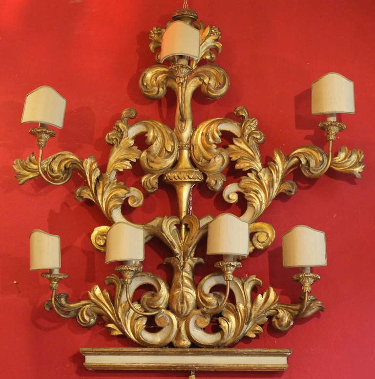 Make a statement of elegance in your home with this large and important hand carved gilt wood and lacquer wood applique from Florence, Italy dating back to 19th century.
This wall light is formed as an opposing pair of pierced and scrolling