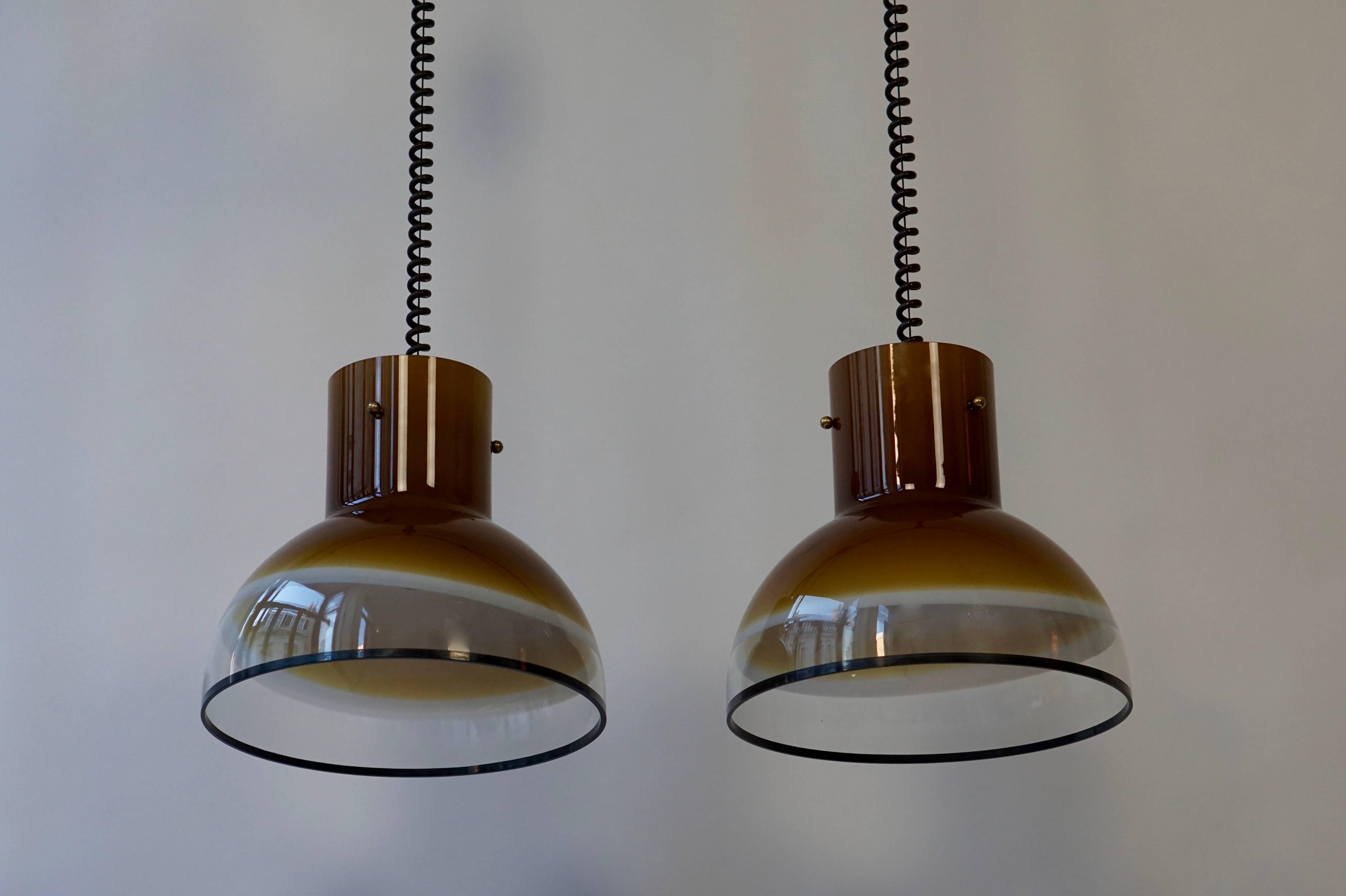 A set of two gorgeous Italian Murano ceiling lights from the seventies.
The height can be adjusted from 29.52 inches to 51.18 inches, the diameter of the glass is 13,77 inches.