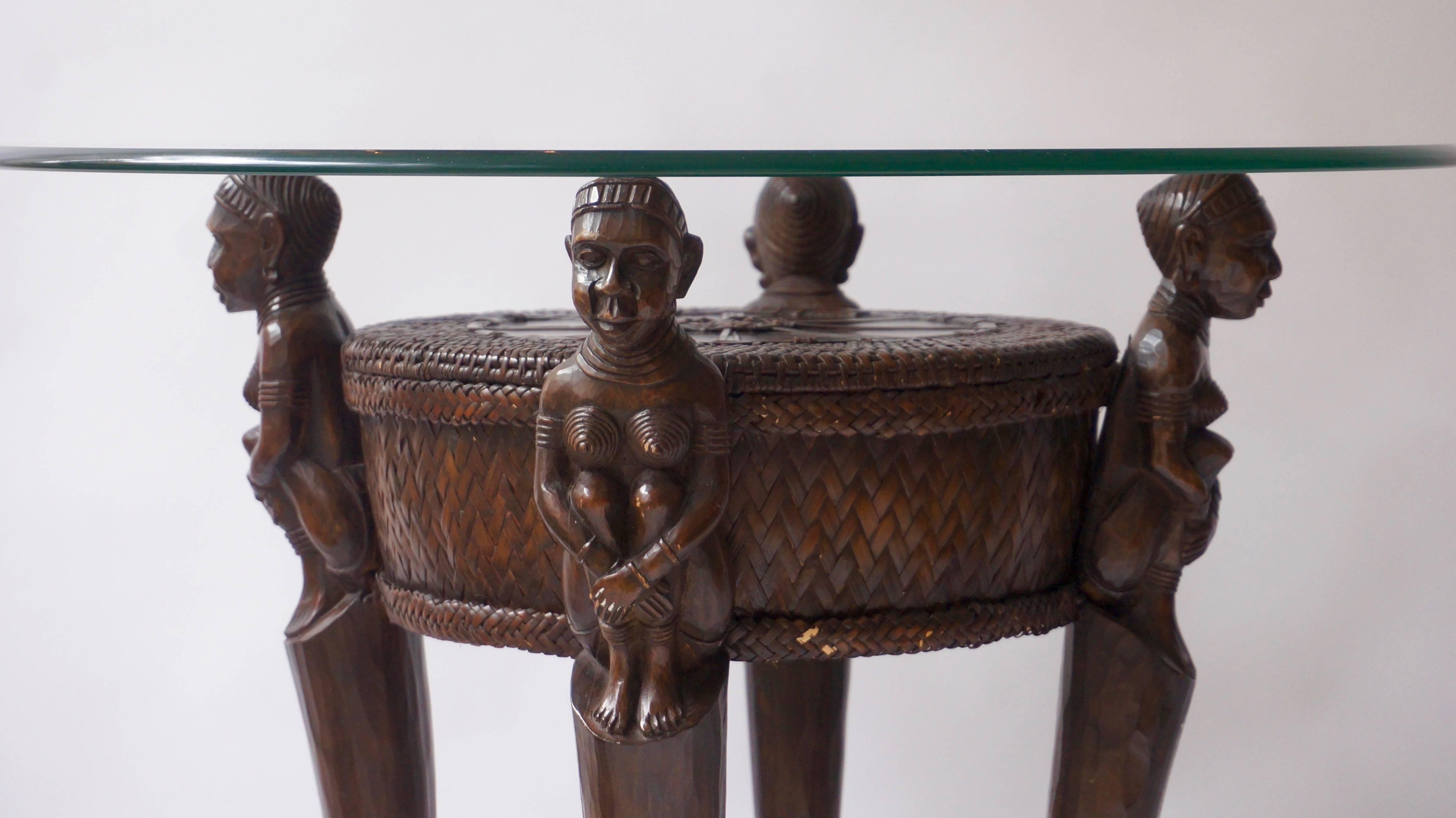 Colonial tribal side table from Congo.
Diameter wood 50 cm.
Diameter glass 70 cm.
Height 65 cm.