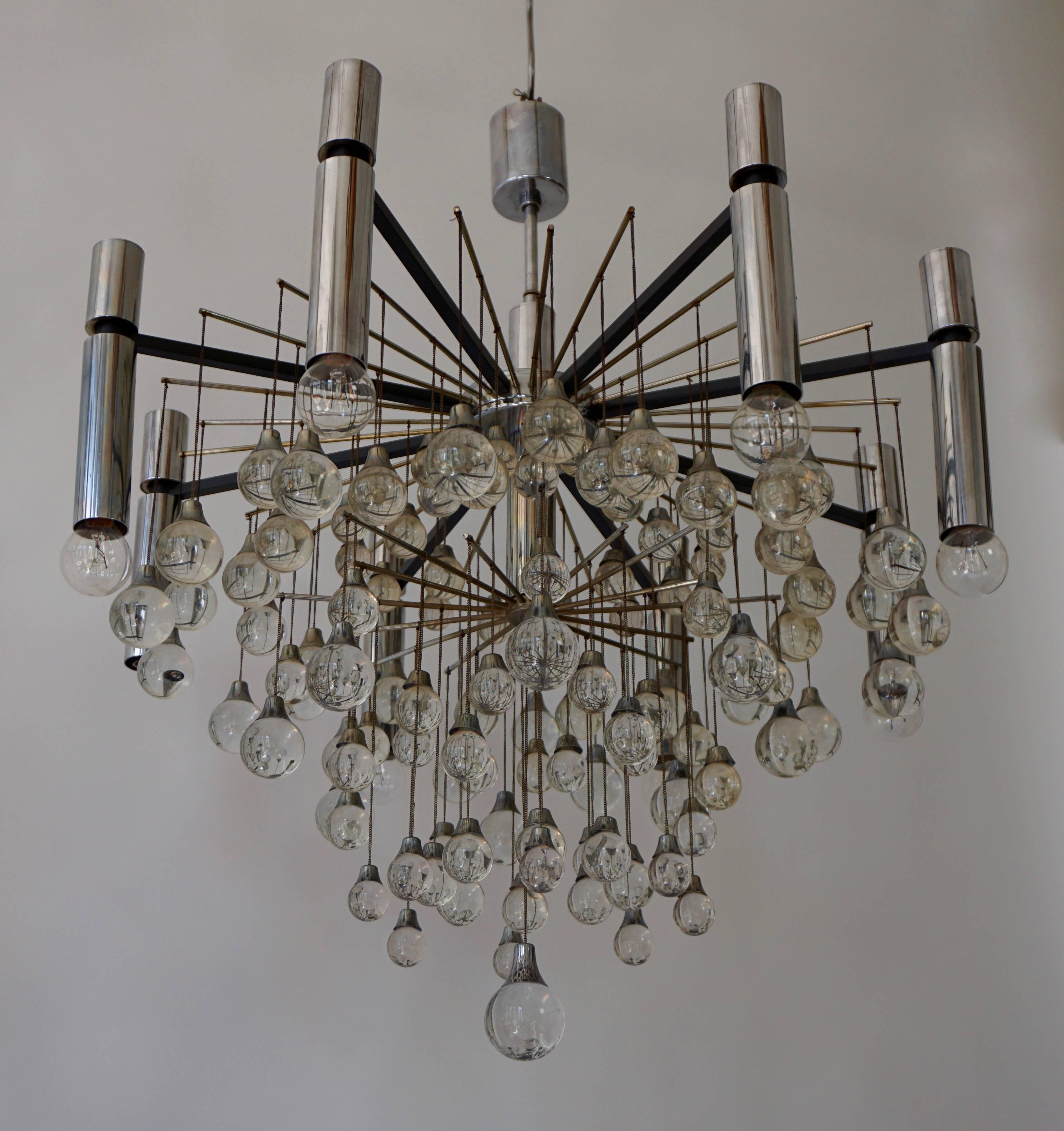 Two Gaetano Sciolari Crystal Drops Chandeliers.

Materials: Round lampshade made of chromed metal rods, tubes and parts in iron and brass. Black rectangular rods. Thin brass rods. Crystal bubble glass beads or pearls in a drop form. Metal chains.