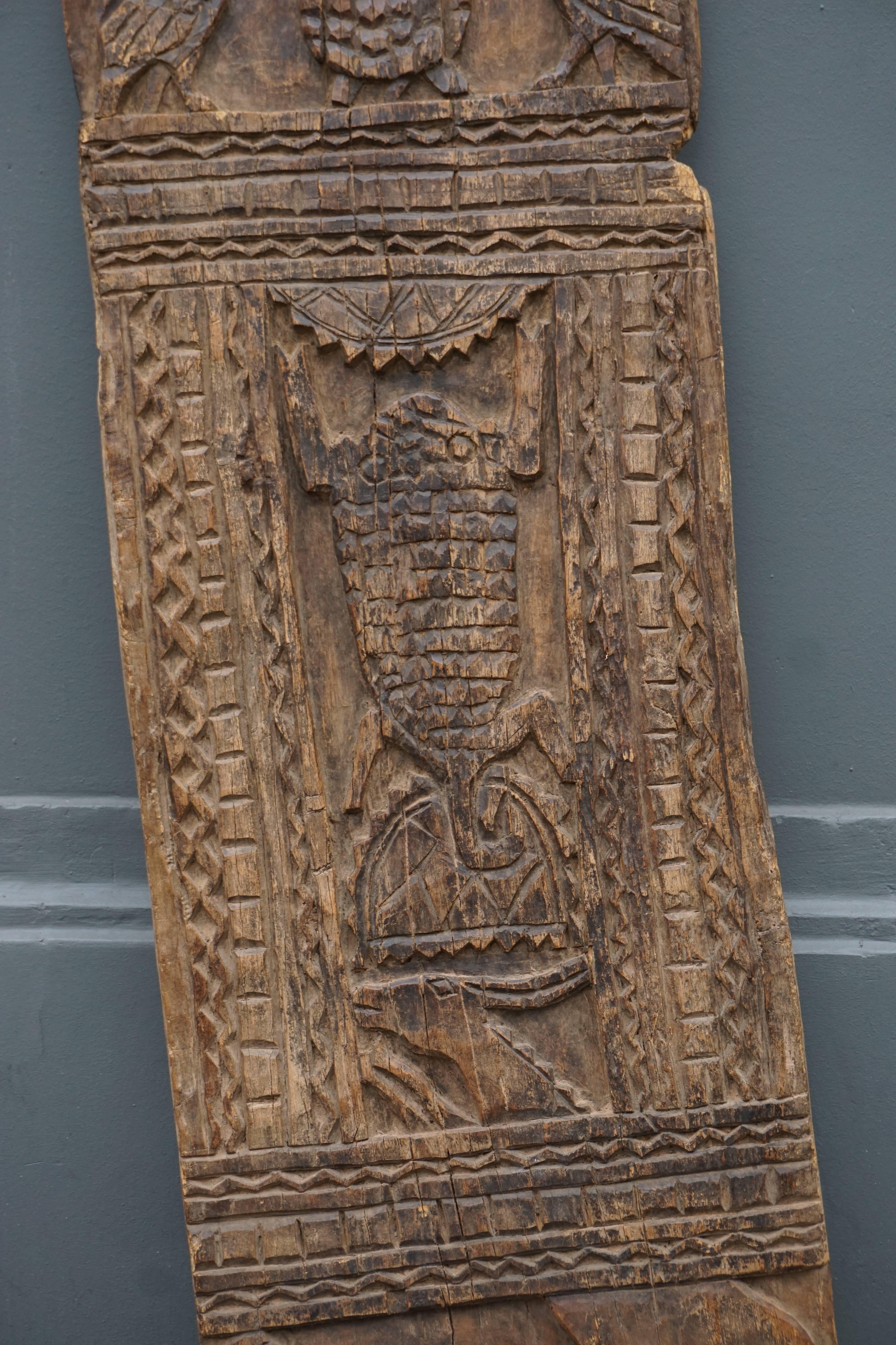 Old wooden hut door from Cameroon, decorated with carved ibis turtle, antilope and hunting scene within geometric ornament in the traditional ethnic style.
Superb old door African sculpture.