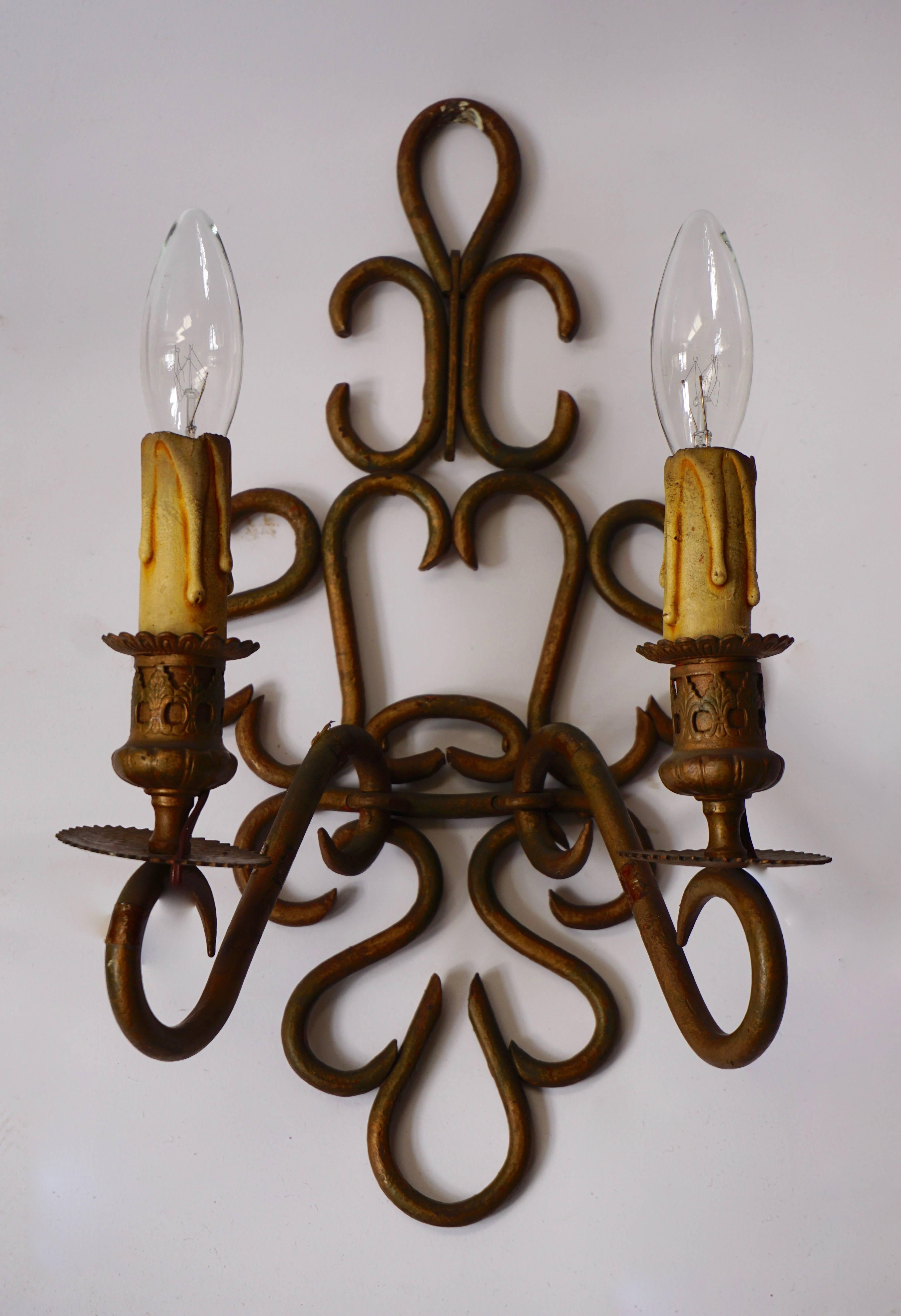 A pair wrought iron wall lights.
 