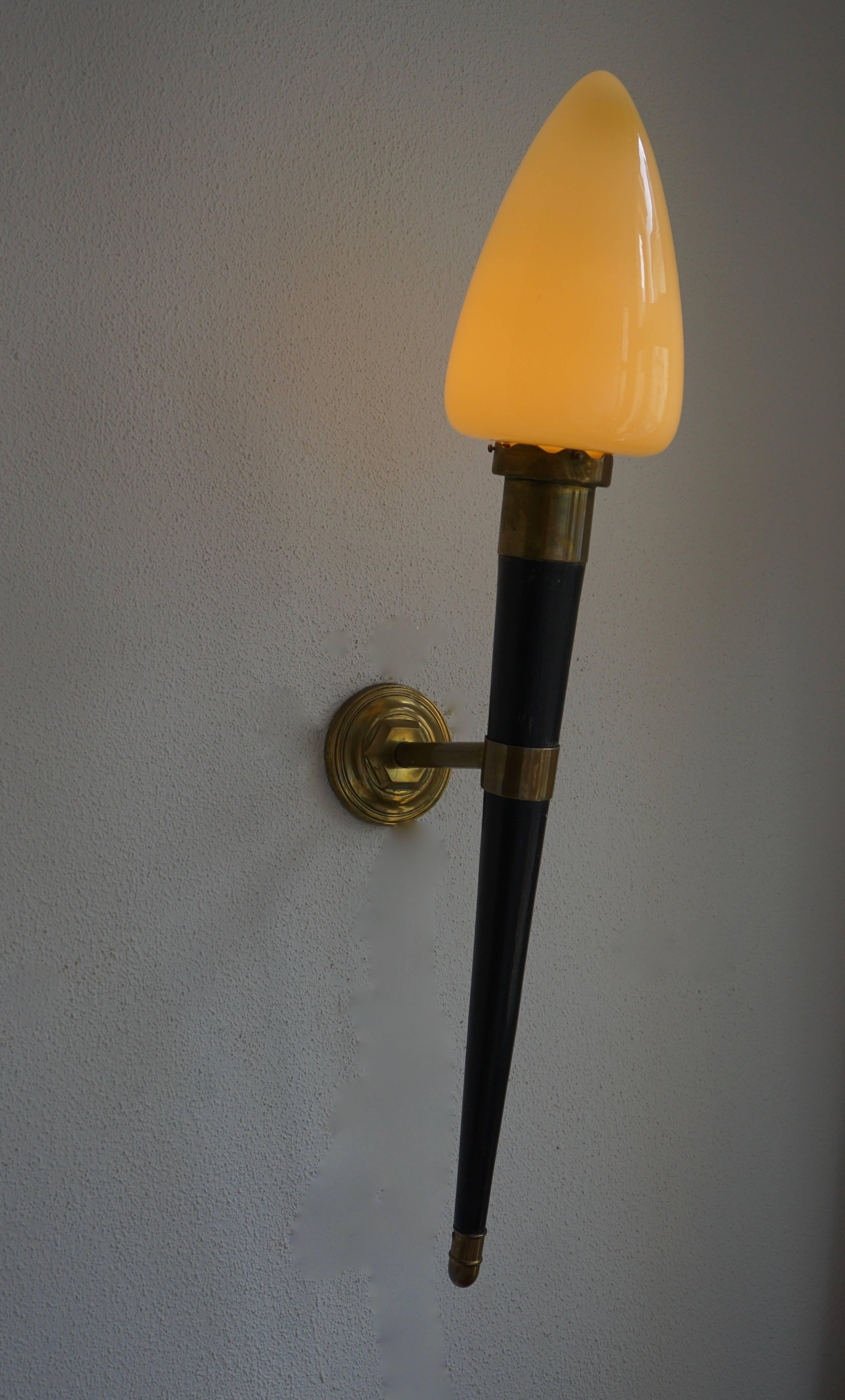 For your consideration a pair of vintage wall sconces. Solid brass, wood and glass. Made in Italy.

Sculptural shape. Requires one bulb per sconces. E-27, 25 to 40 watts. 

Measures: Height 90 cm.
Diameter 17 cm.
Depth 36 cm.
    