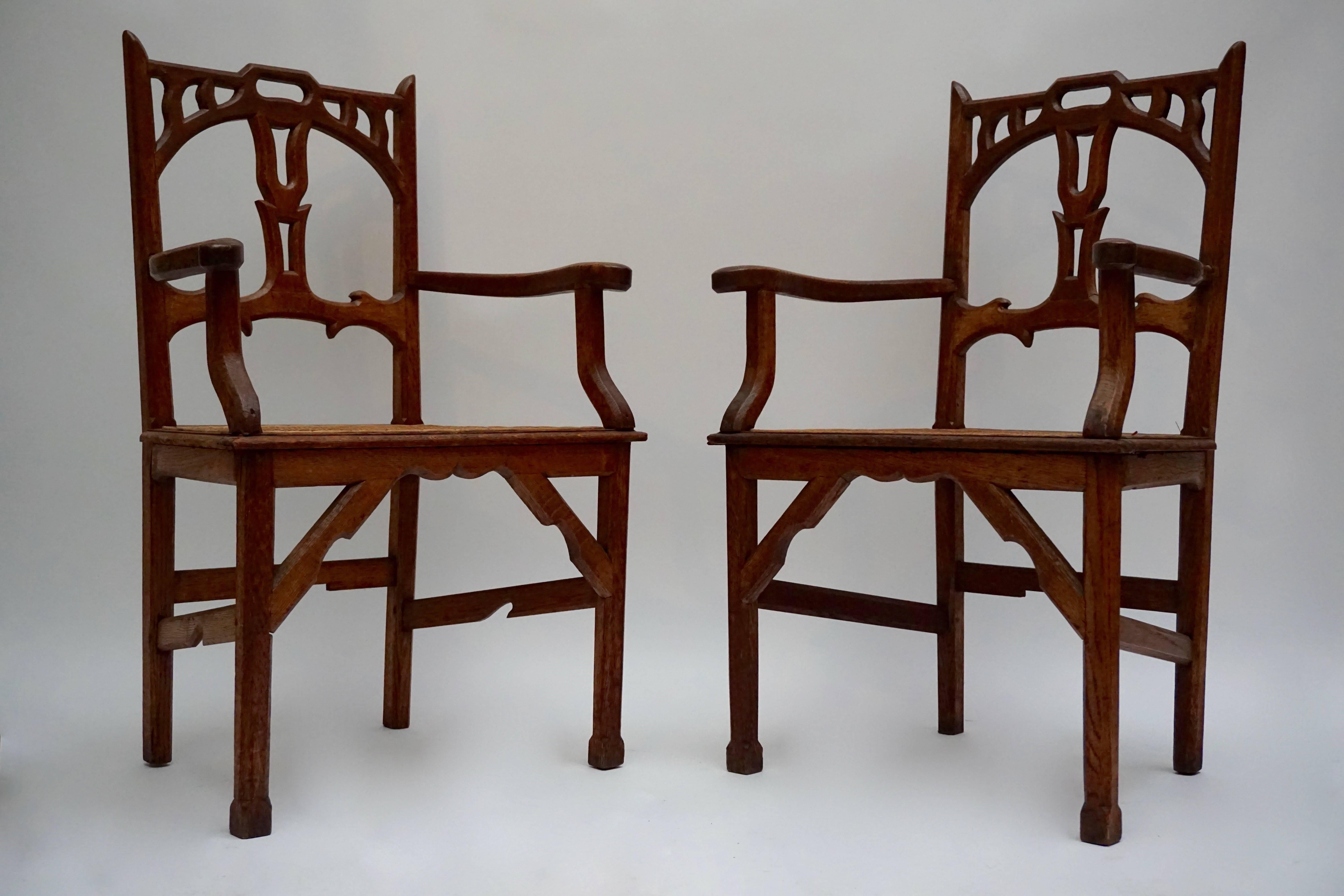 Pair of Art Nouveau carved teak armchairs with wicker woven seats.
 