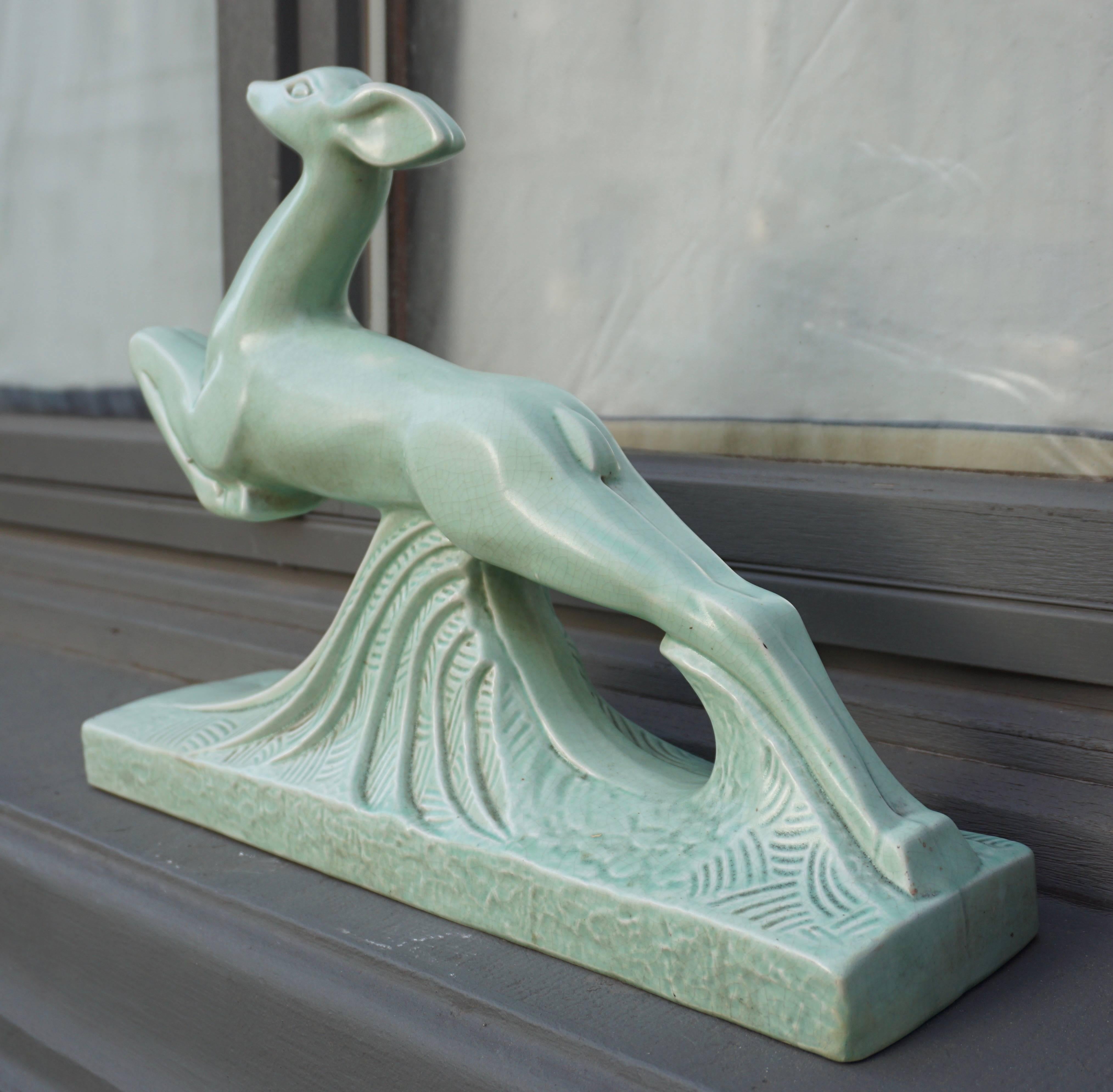 An Art Deco green crackle glazed ceramic figure of a leaping deer, signed `Cassin`.
Width 45 cm.
Depth 12 cm.
Height 34 cm.
Cassin - Crackle ceramic 'Doe.